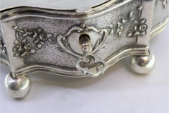 Jewelry box, in embossed silver with floral motifs surrounding the card