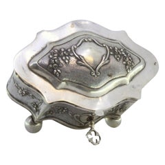 Jewelry box, in embossed silver with floral motifs surrounding the card
