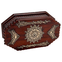 Jewelry box, in rosewood with raised silver accents and trembles