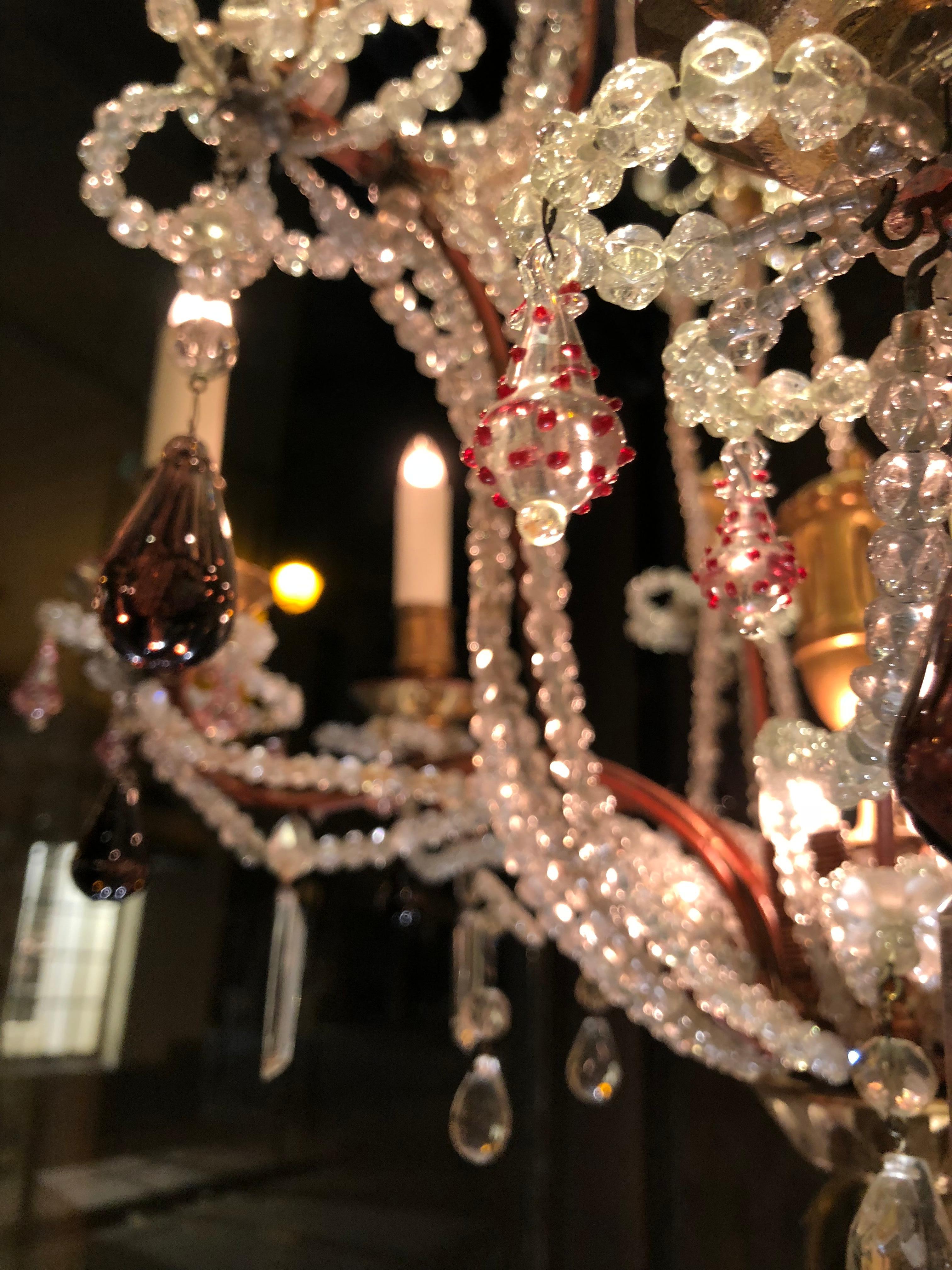 Wonderful jewelry chandelier, decorator’s work made from old elements, grape pearls, Murano blown glass beads and crystal.
5 lights,

circa 1930.