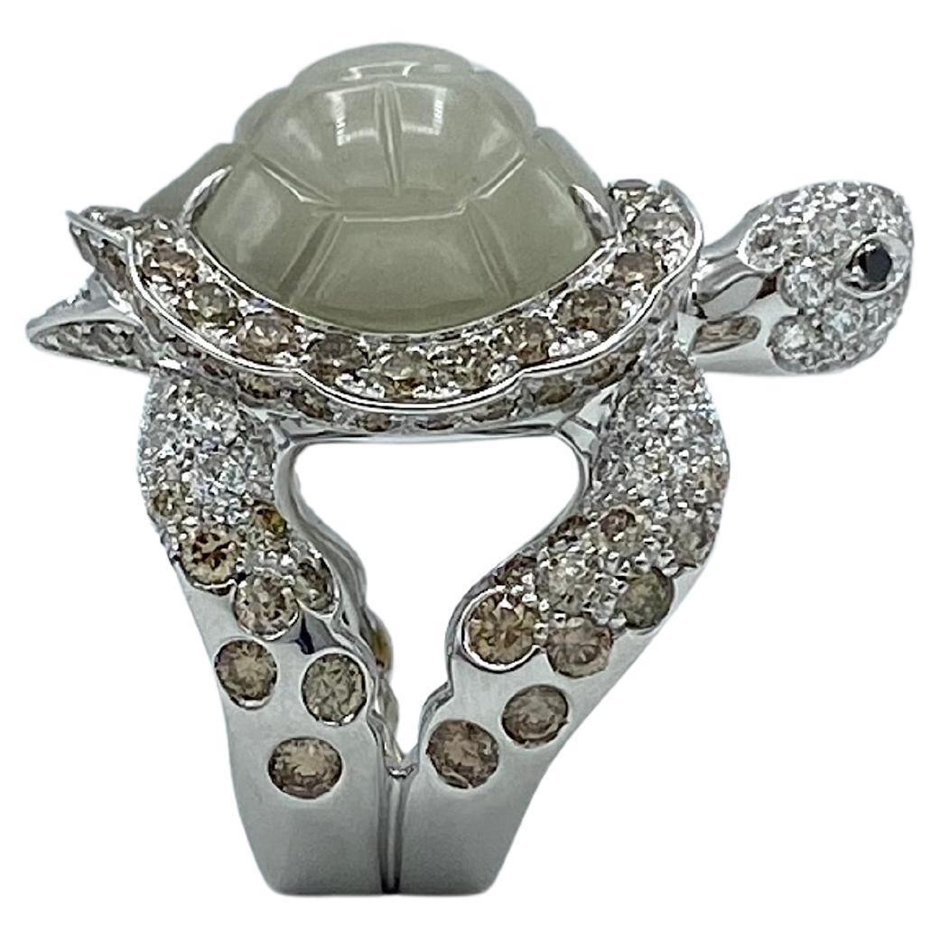 This is a very beautiful white gold ring with white, brown and black (their eyes) diamonds.
The 