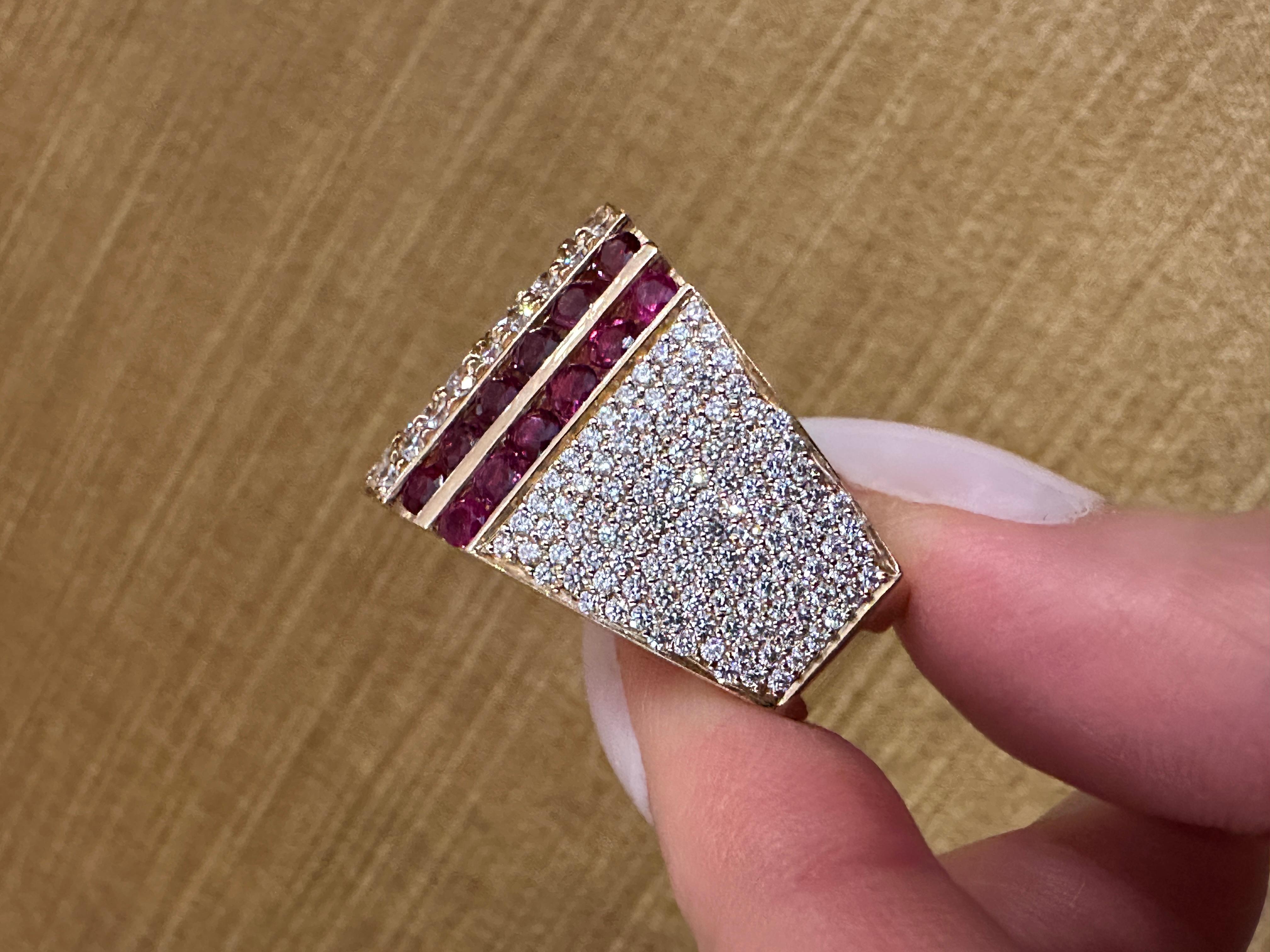 Wide Band Ruby and Diamond Ring in 14 Yellow Gold

Ruby and Pave Diamond Ring features Natural Round Full-cut Brilliant Diamonds set in vertical rows with Round Rubies channel-set in 5 rows set in 14k Yellow Gold by Jewels of Gauthier of Scottsdale