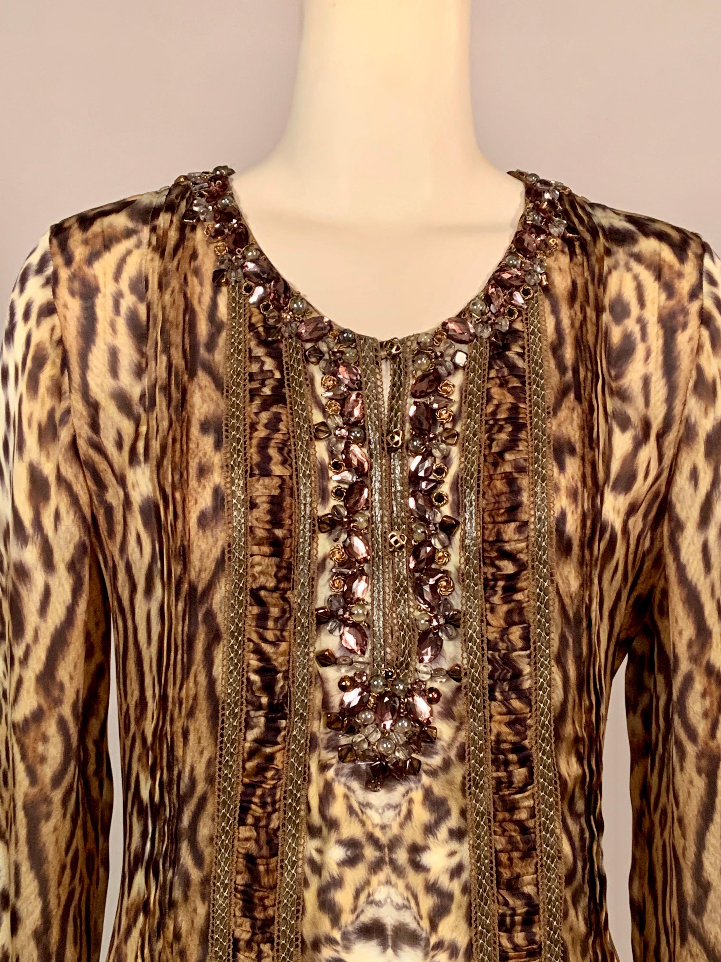 The very best blouse ever!  This stunning animal printed silk chiffon blouse designed by Oscar de la Renta has a lavish collar and bib front hand sewn with layered jewels in all shapes and sizes and many beautiful colors.  If that is not enough the