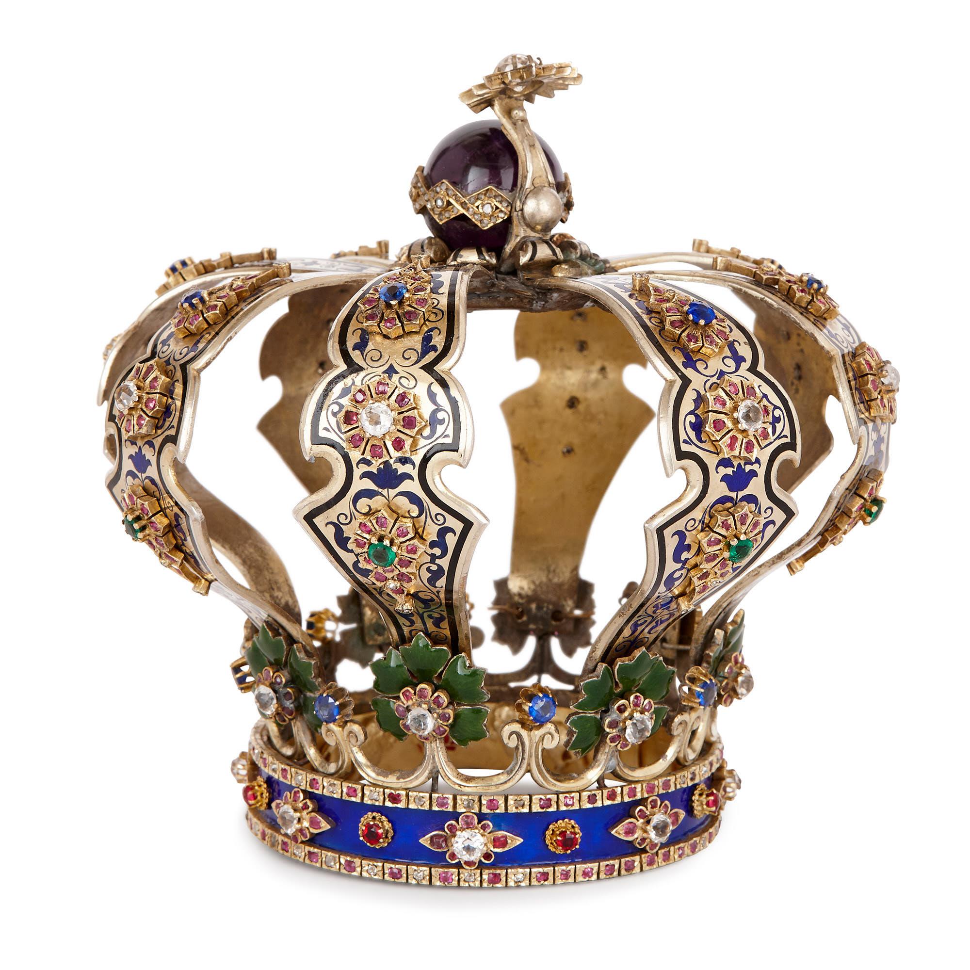 This Torah crown is a small (15cm high), exquisitely-crafted and lavishly-decorated piece of Judaica. 

The Torah – the first of five books of the Hebrew Bible – is central to the Jewish faith. It is written onto a scroll, which is wound in
