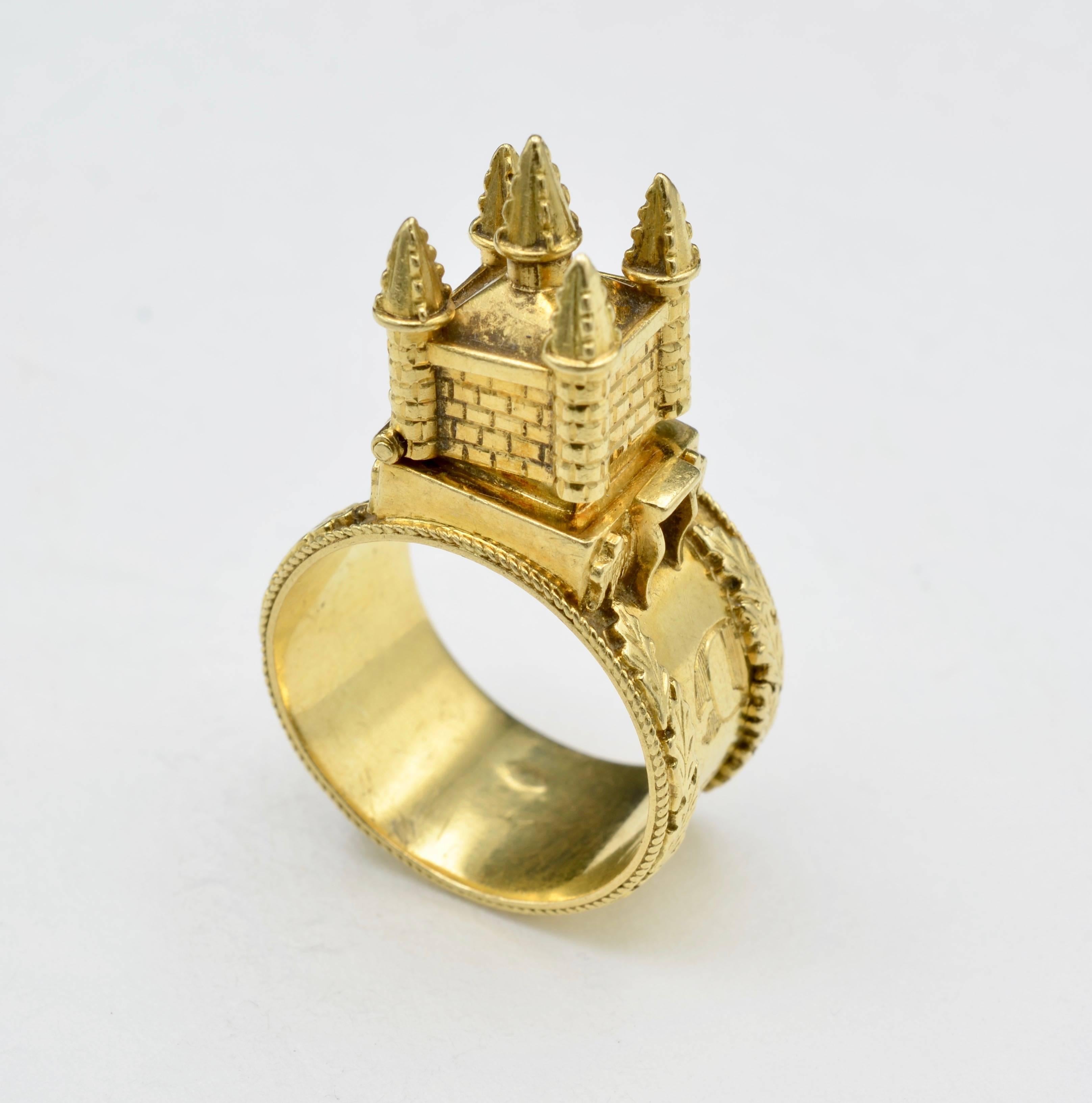 This yellow gold ring Castle with the a claps open to an enamel word. 
These unique and opulent rings featured wonderful miniature palaces, castles and temples, standing proudly in the place of a gemstone, and were often inscribed with Hebrew. The