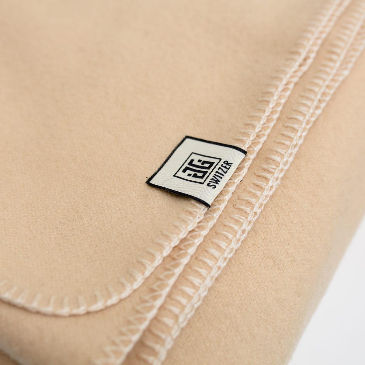 The Classic blanket in Sunshine Yellow is a tailored blanket exclusively made by JG SWITZER in 100% Merino Wool. Blanket stitch is done in house at our workshop in a lovely cream color. Milled in England from soft and high-quality Merino wool in an