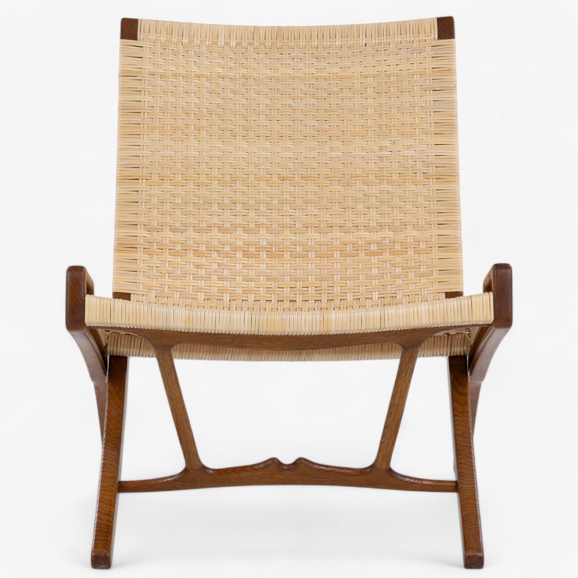 JH 512 - Folding chair in patinated oak with new wicker. Designed in 1949 by Hans J. Wegner and stamped by the manufacturer Johannes Hansen.