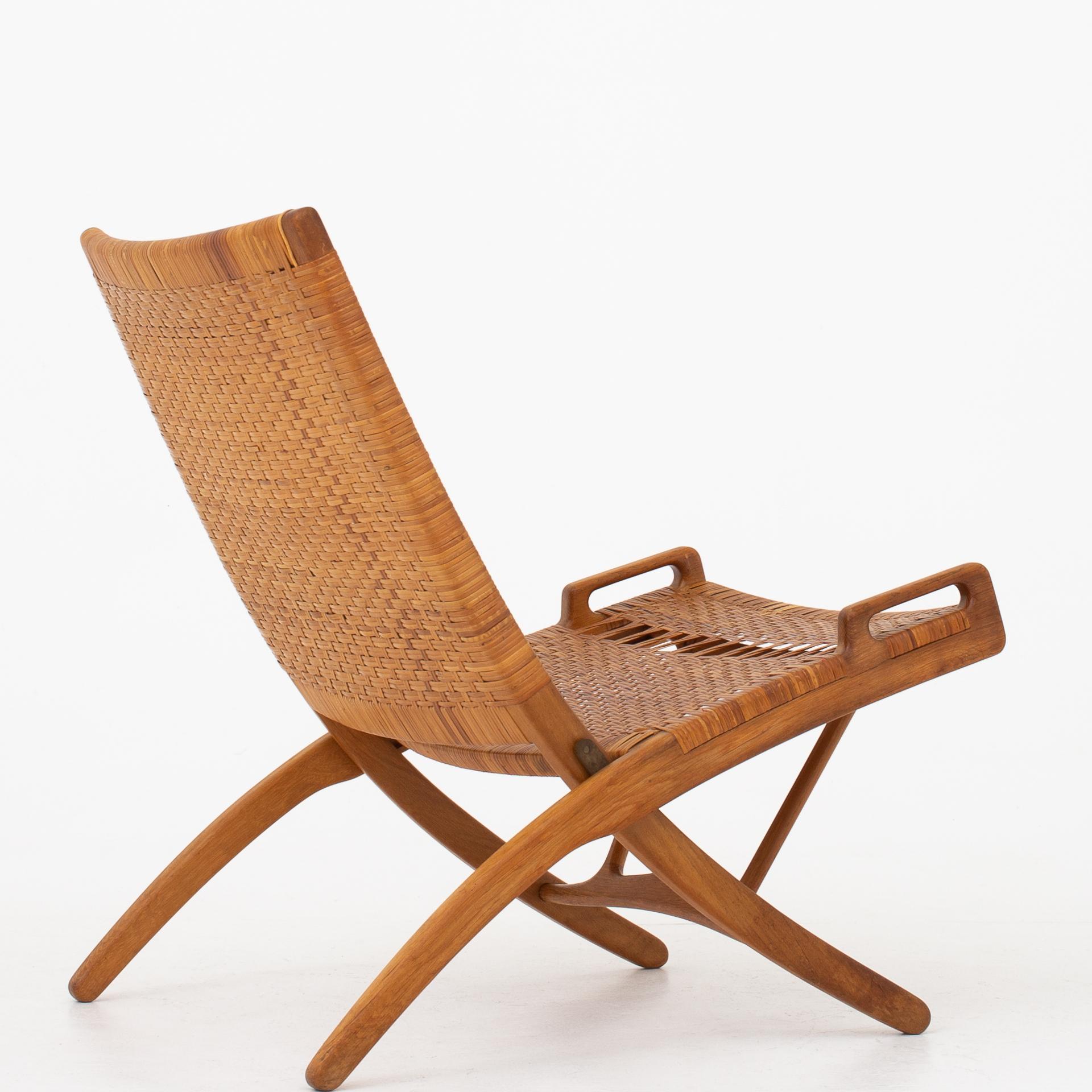 JH 512 - Folding chair in patinated oak with original cane webbing. Marked. Designed 1949. Maker Johannes Hansen.