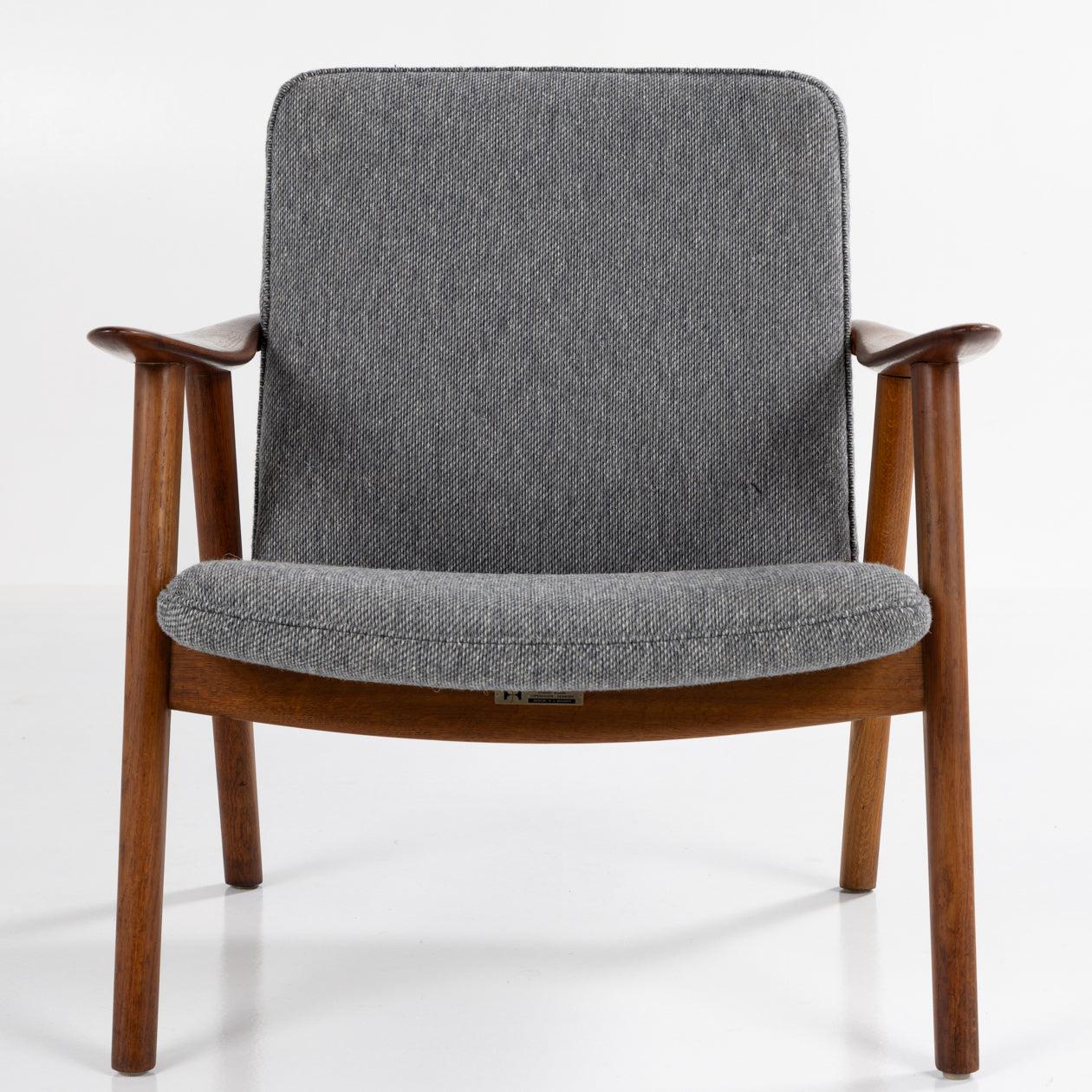JH 517 - 'Buck Chair' in patinated teak and new textile from Kjellerup Væveri (COLOR 10-109) with manufacturer's label. Hans Wegner for master cabinetmaker Johannes Hansen.