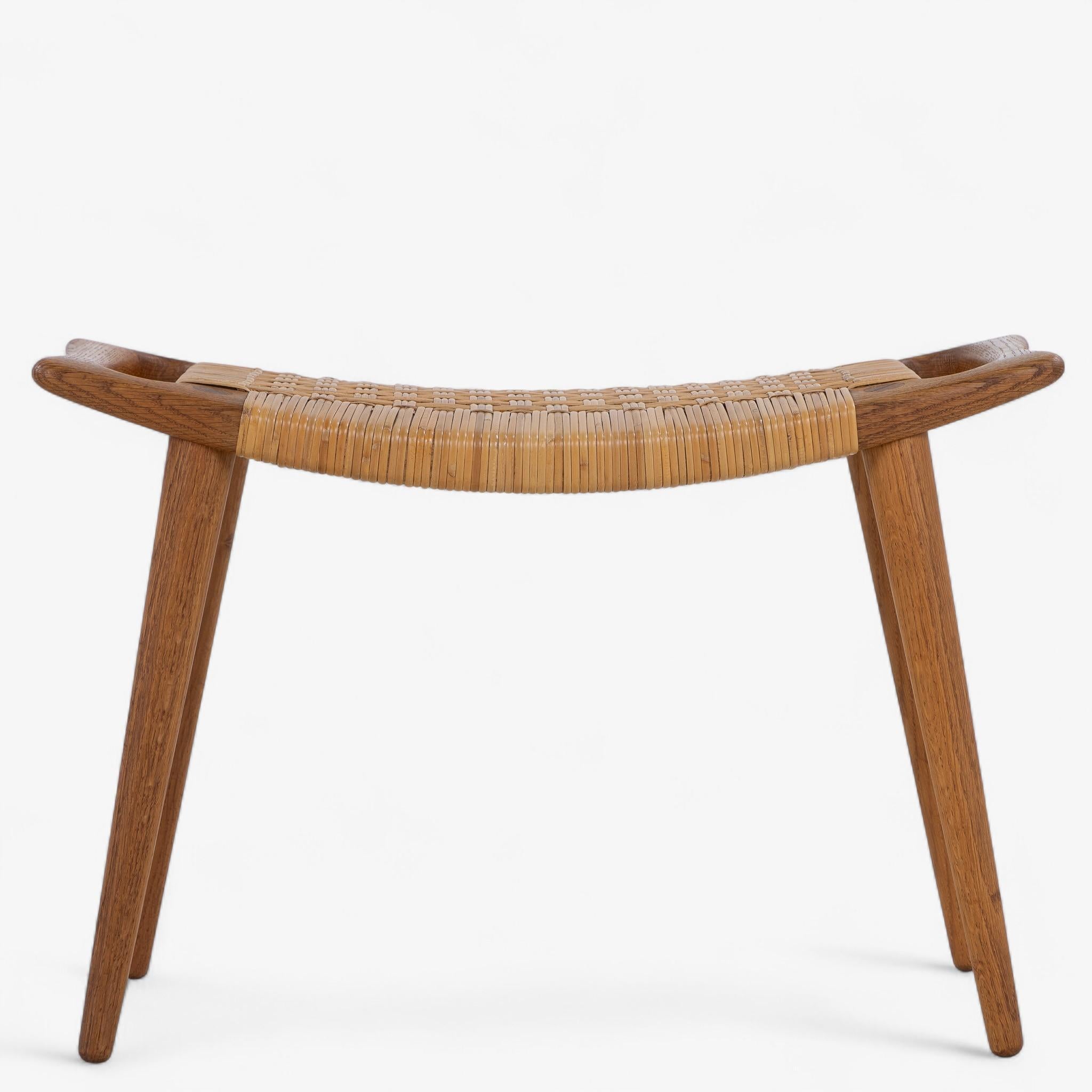 JH 539 - Stool in patinated oak with a seat in wicker. Marked by the manufacturer Johannes Hansen and designed by Hans J. Wegner.