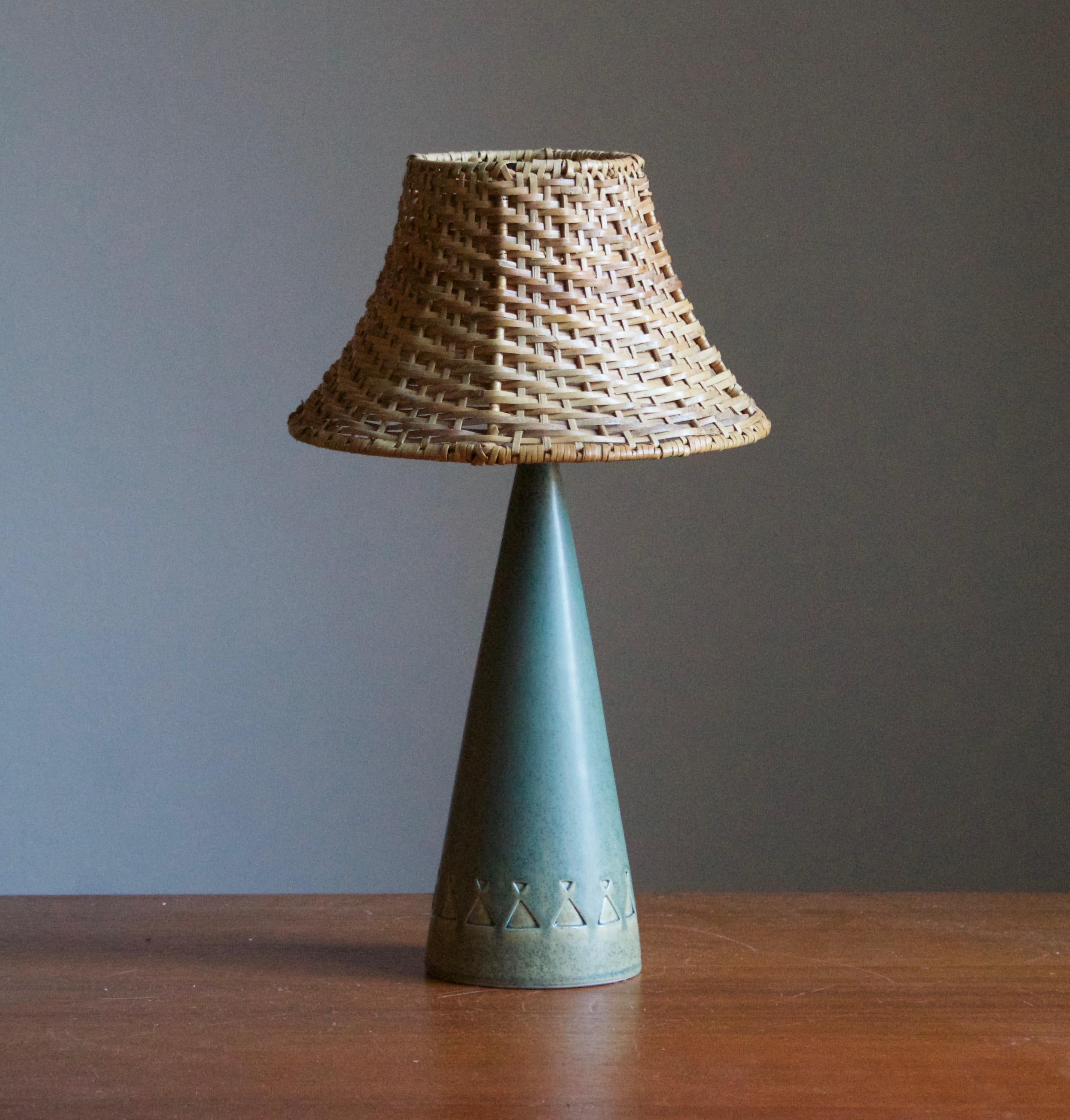 A stoneware table lamp designed and produced by Jie Gantofta, Sweden, c. 1960s. Stamped

Stated dimensions exclude lamsphade. Height includes socket. Illustrated model vintage rattan lampshade can be included upon request.


  