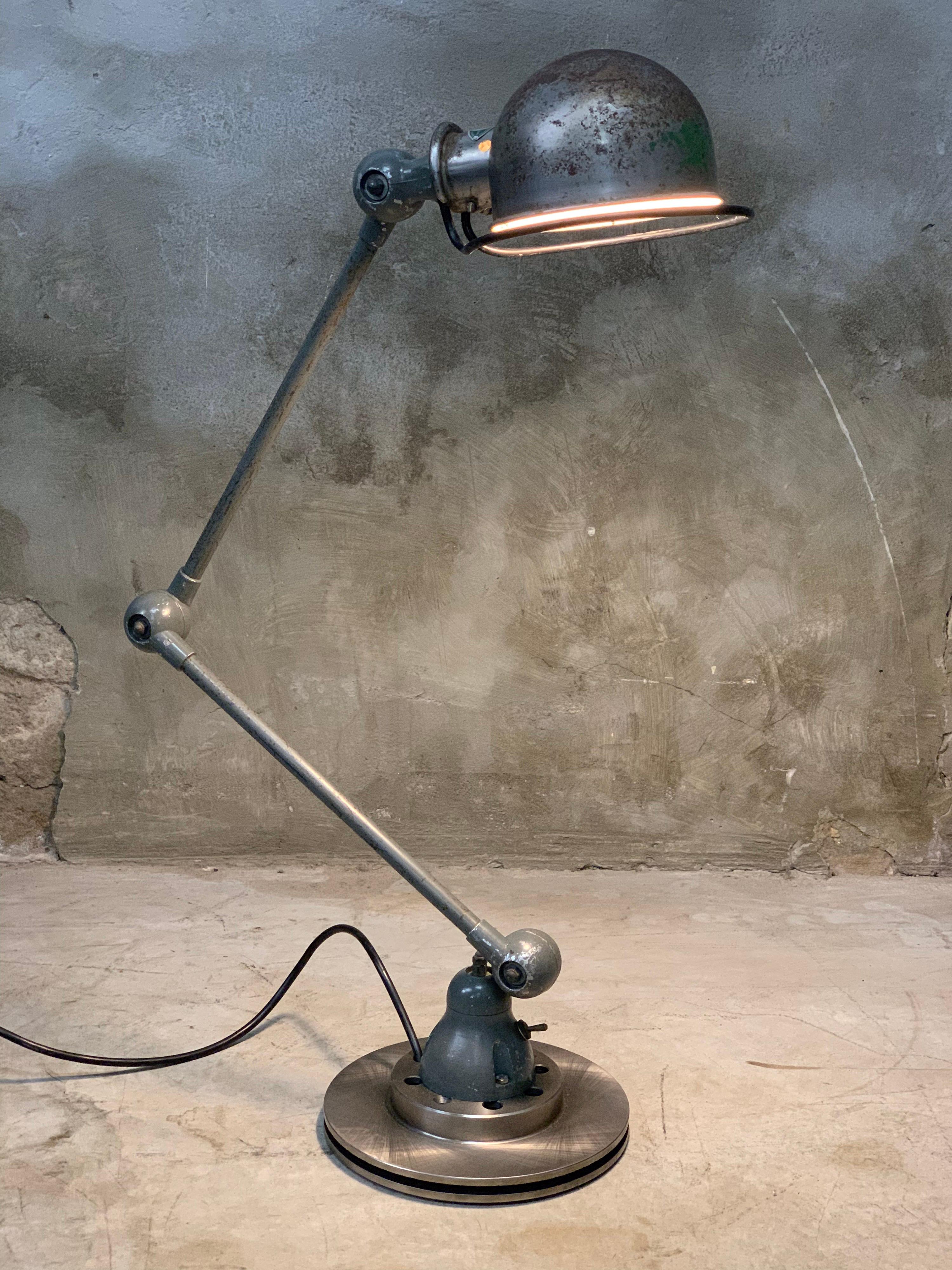 Industrial lamp by Jean-Louis Domecq for Jieldé, France, 1960s. This old Jieldé Table Lamp has 2 arms. Fantastic design icon in a very nice condition. Wear consistent with age and use. Mounted on a brake disc with normal e27 fitting, rewired and has