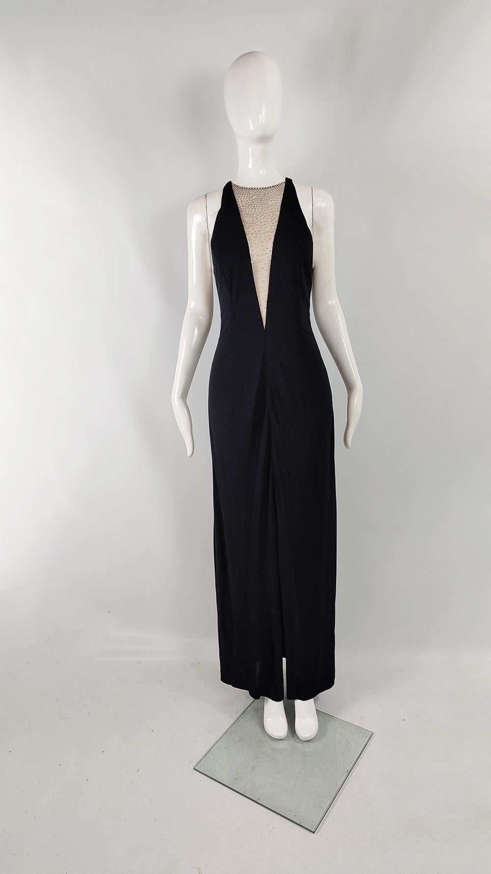 A breathtakingly sexy vintage womens evening gown from the late 80s / early 90s by luxury Monaco-based fashion house, Jiki of Monte Carlo. In a black jersey with scandalous, racy cut outs in a nude tulle creating a plunging back, sides and neckline.