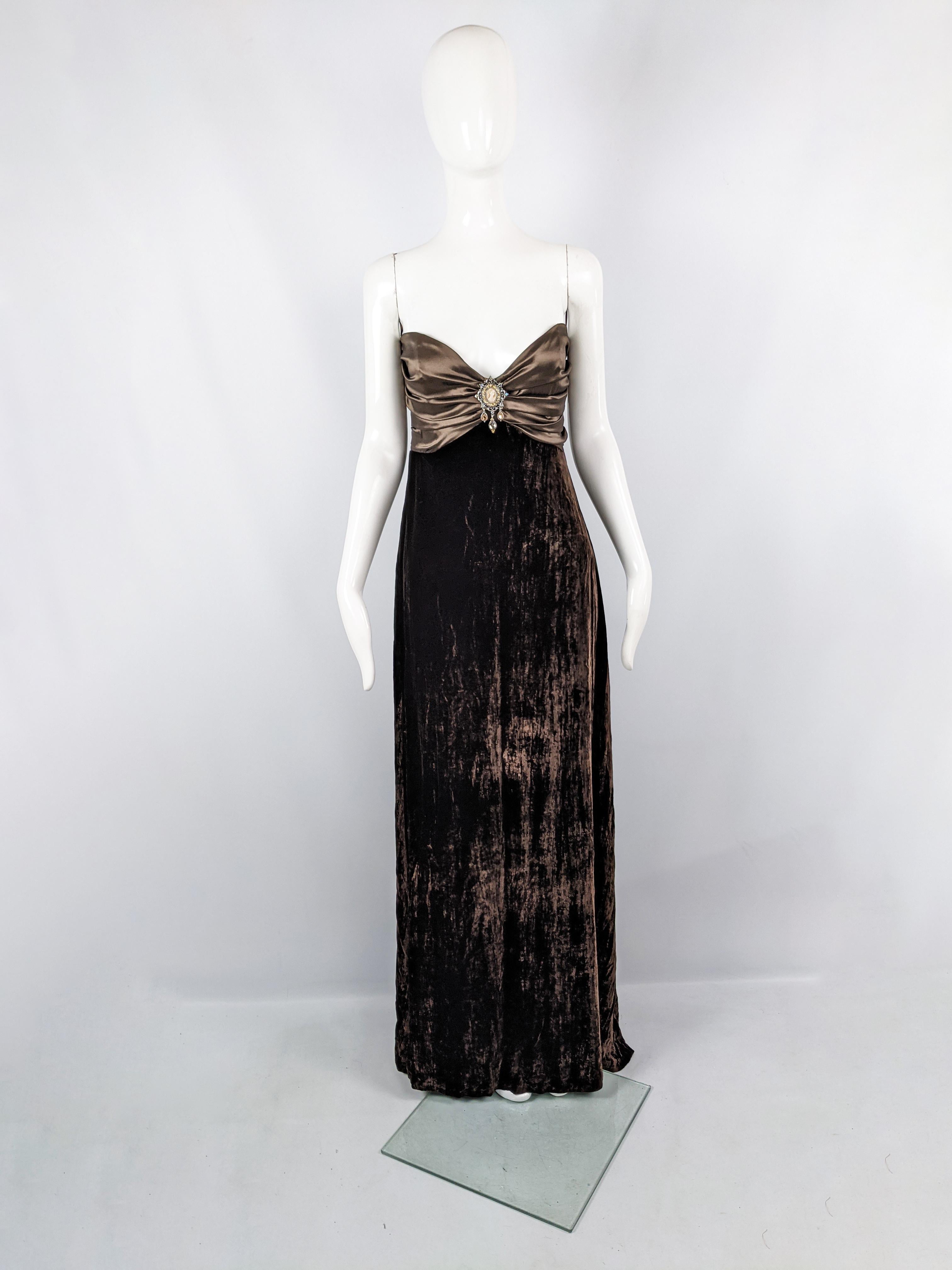 An ultra glamorous vintage evening gown from the 90s by luxury French designer, Jiki of Monte Carlo. Made in France, from a brown stretch velvet with a pleated satin bust. It has a deep plunging sweetheart neckline embellished by a beaded cameo