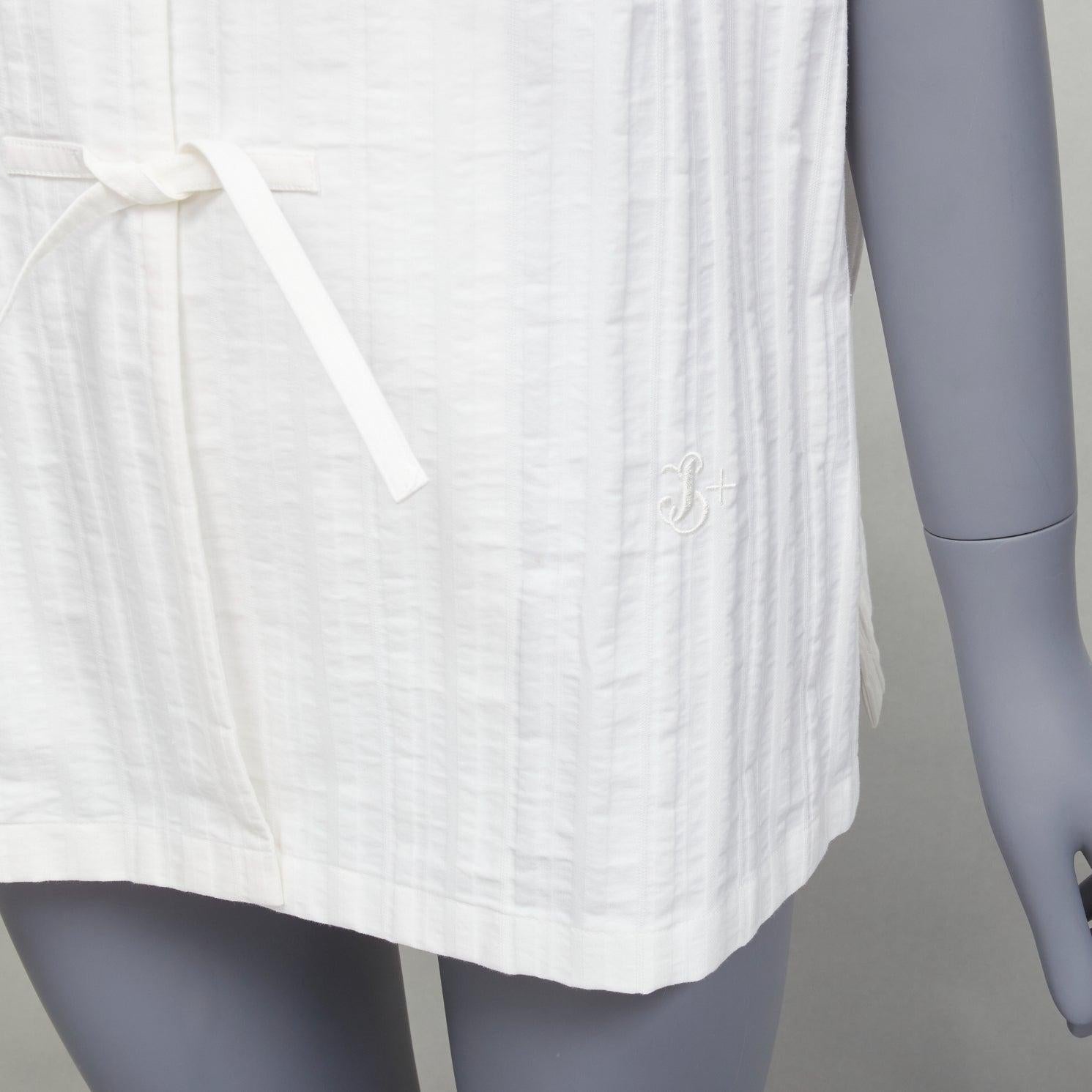 JIL SANDER 2019 white striped logo tie button mandarin collar boxy shirt FR34 XS
Reference: LNKO/A02162
Brand: Jil Sander
Collection: Jil Sander+
Material: Cotton
Color: White
Pattern: Striped
Closure: Self Tie
Extra Details: Tie buttons. Vetical