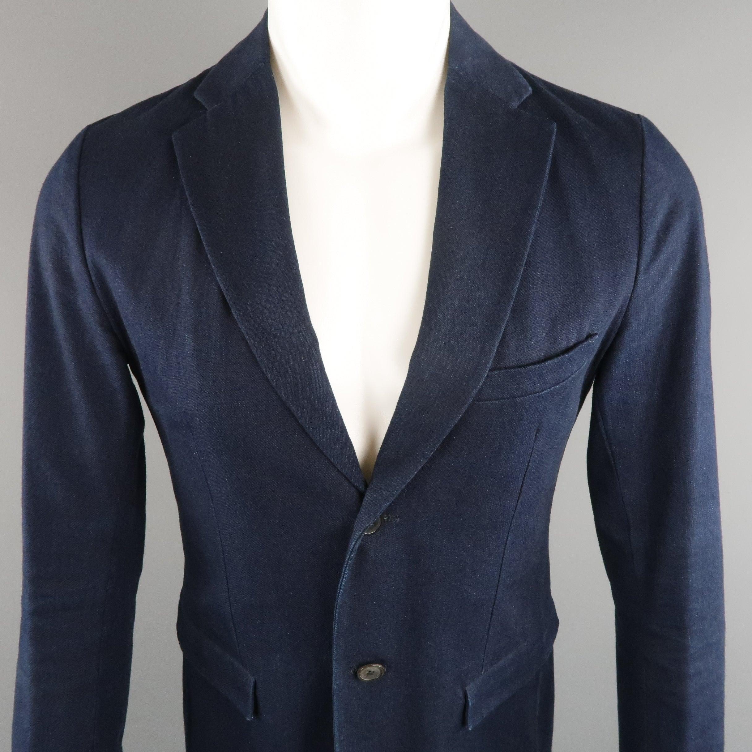 Single breasted JIL SANDER sport coat jacket comes in navy blue solid denim, with notch lapel, two button front, two front flap pockets and single vent on the back. Made in Italy.Good Pre-Owned Condition. Some marks of use on the chest and cuffs.