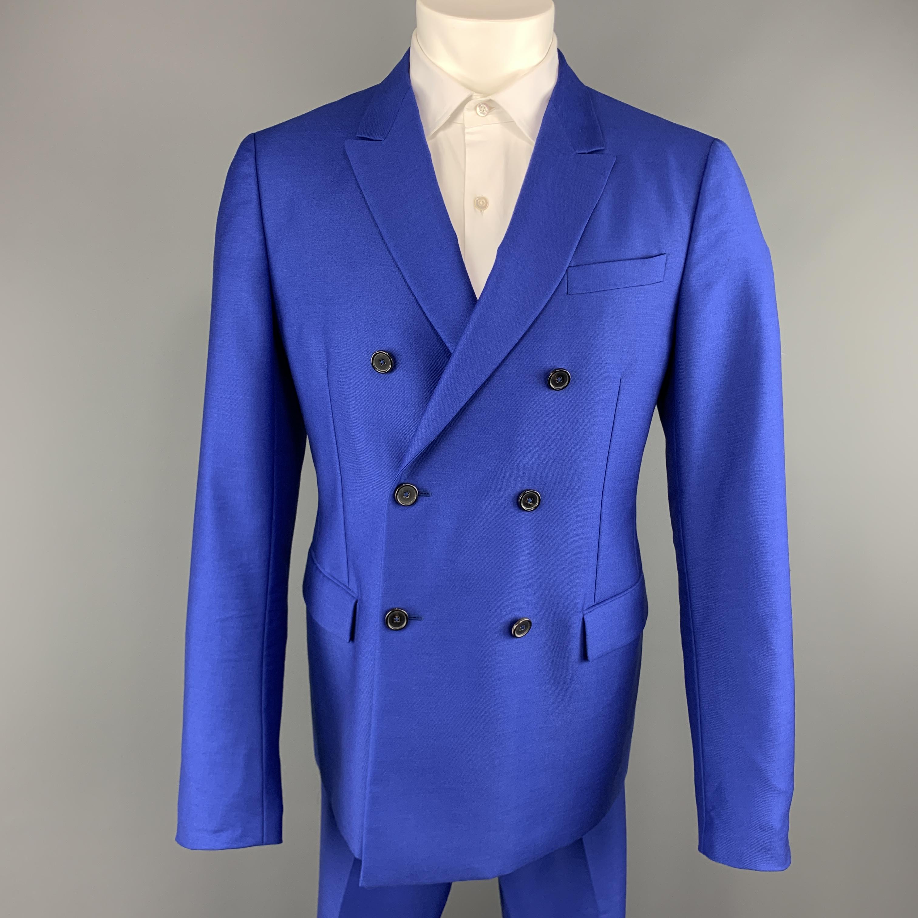 JIL SANDER by RAF SIMONS suit comes in bold royal blue mohair wool blend twill and includes a double breasted, peak lapel sport coat and matching flat front, cuffed hem trousers. Made in Italy.
 
Excellent Pre-Owned Condition.
Marked: IT 52
