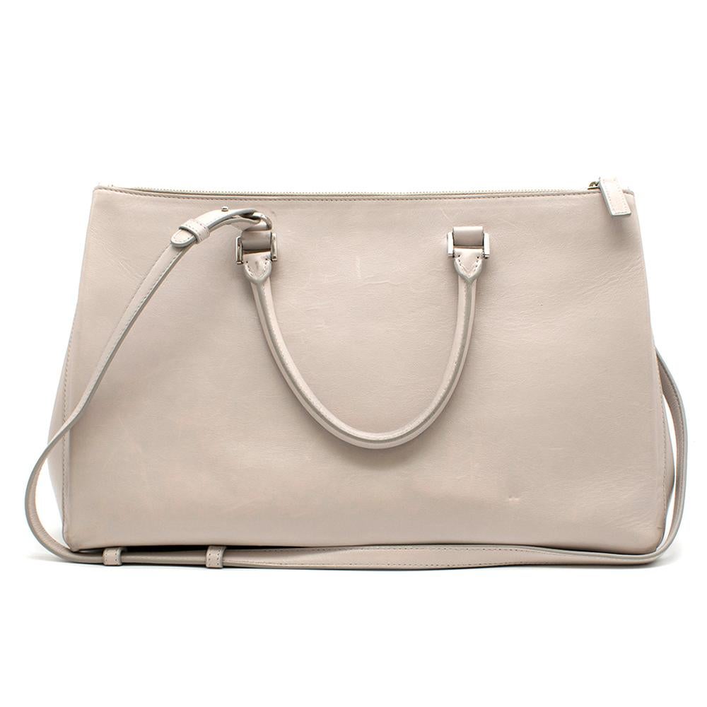 Jil Sander Beige Leather Tote Bag

Beige Handbag,
Rolled leather handles,
Detachable shoulder strap,
Three interior pockets with three internal compartments in either side,
Soft red leather interior,
Silver hardware,
Two exterior pockets on either