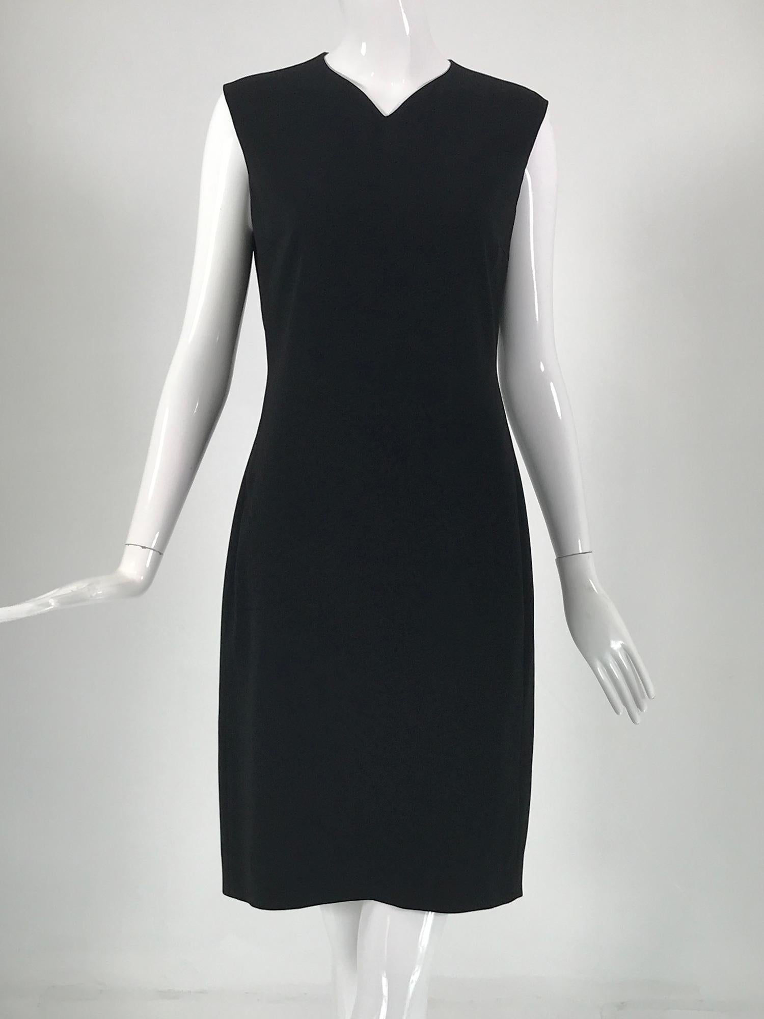 Jil Sander black crepe sleeveless sheath dress with peek a boo back. V neck dress, with curved waist center back/back side seams to the hem, the seaming accentuates body shape. The upper back has peek a boo vertical openings at each side to the
