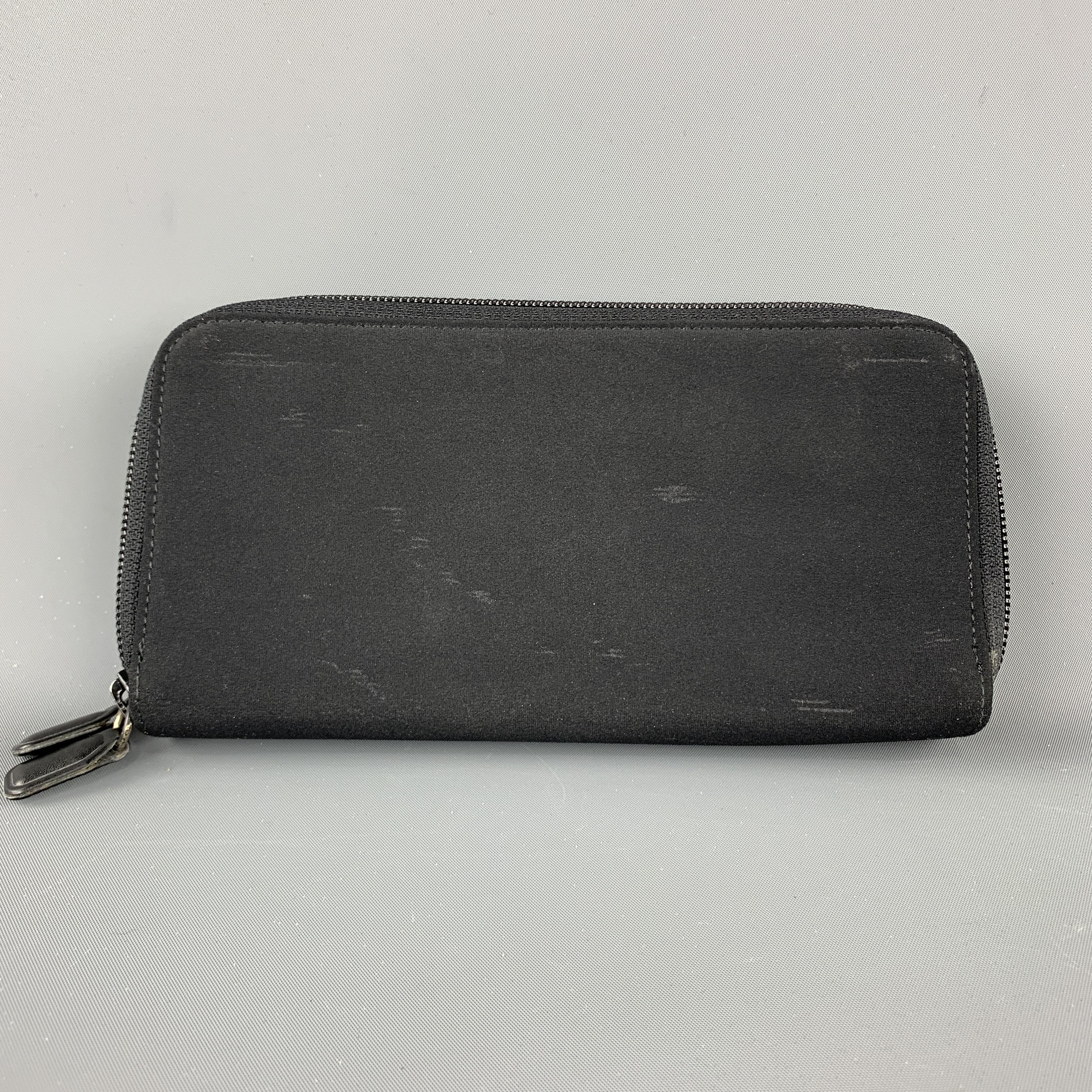 JIL SANDER Wallet / Purse comes in a black tone in a solid canvas material, with internal leather, card slots, dollar bill compartments and a double zipper. Minor wear at canvas. Made in Germany.
 
Good Pre-Owned Condition.
 
Measurements:
 
Length: