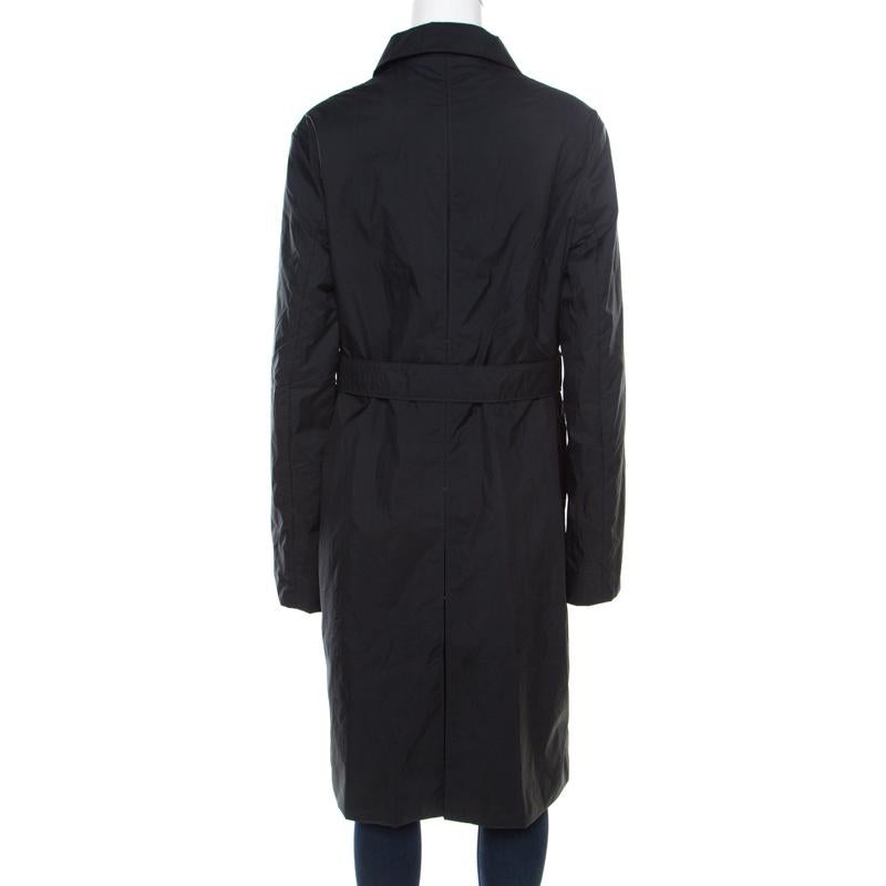 Add this Jil Sander overcoat to your winter collection to get warm and cozy. This chic black piece can be worn with both day and evening looks. Designed in durable nylon, this overcoat features a belt detail at the waist and long sleeves. Wear it