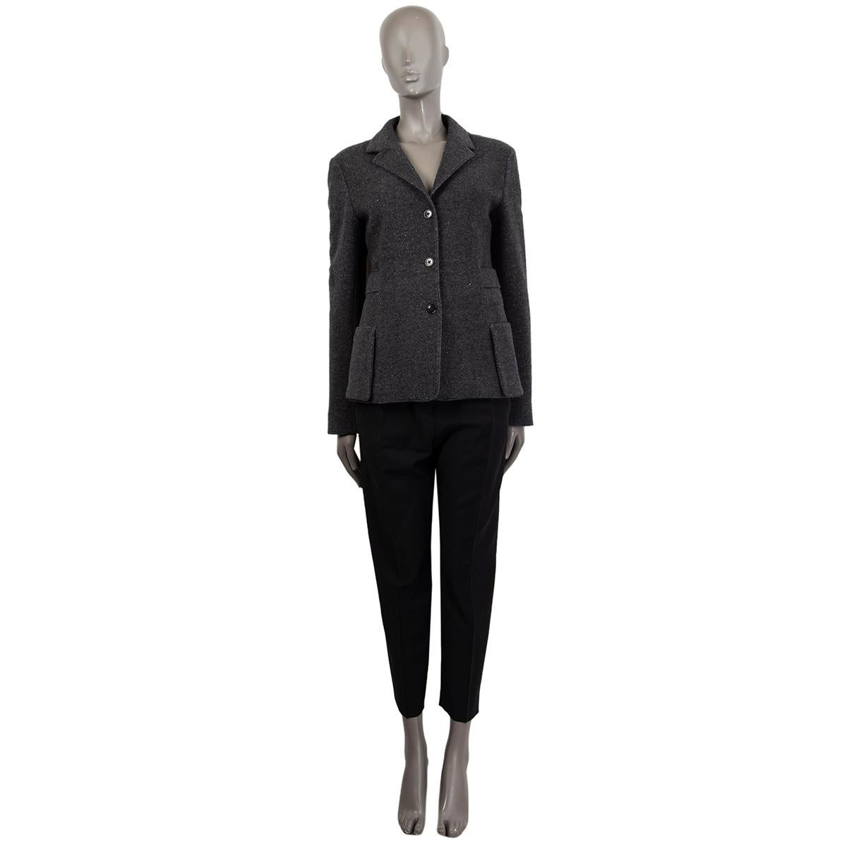 100% authentic Jil Sander buttoned notched collar blazer jacket in grey melange wool (70%) and cashmere (30%). Lined in black polyester (65%) and silk (35%). 2 front patch pockets and waist belt detail around the back. Has been worn and is in
