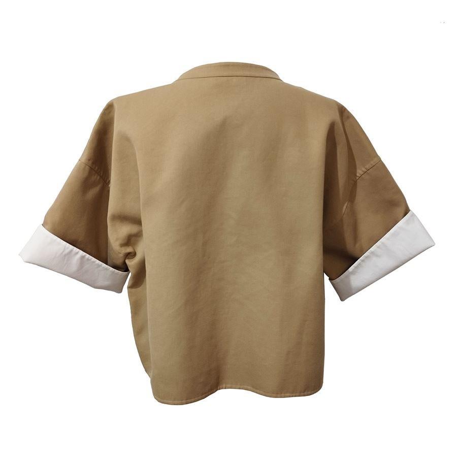Cotton (99%) and silk (1%) Beige color Short sleeve with revers Hidden zip closure Shoulder/hem length cm 48 (188 inches) French size 40 italian 44   