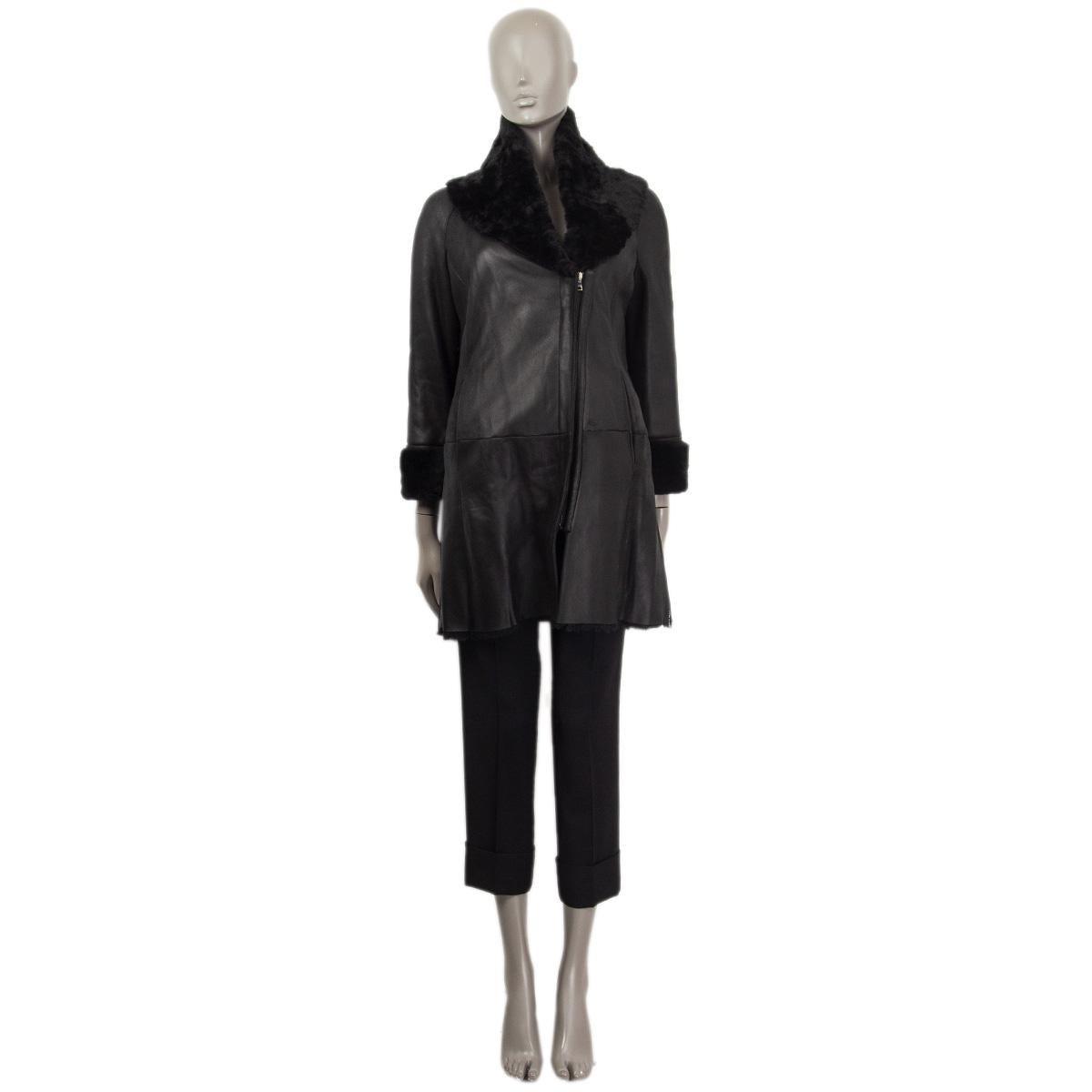 100% authentic Jil Sander NAVY shearling coat in black lambskin featuring a large shawl collar. Opens with a asymmetrical zipper at front and is lined in black lamb-fur. Has two side-zippers and two slit pockets at front. Has been worn and is in