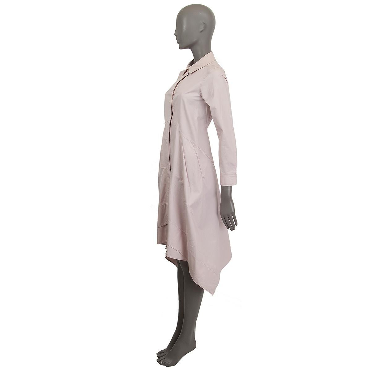 100% authentic Jil Sander longsleeve flared structured shirt dress in pale pink cotton (100%) lined in cotton (74%) and silk (26%). Opens with hidden buttons and has two slit pockets on the side featuring jagged edge. Has been worn and is in