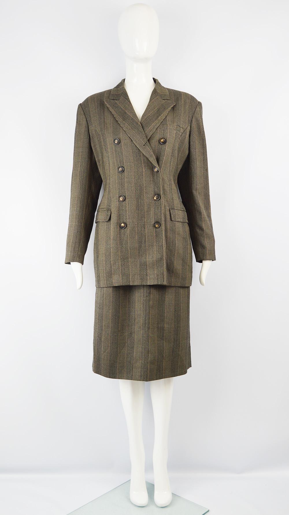 A chic vintage women's skirt suit from the 90s by luxury German fashion designer, Jil Sander. In a pure wool with a striped pattern woven throughout. The longline blazer jacket is double breasted with peaked lapels that gives a menswear inspired