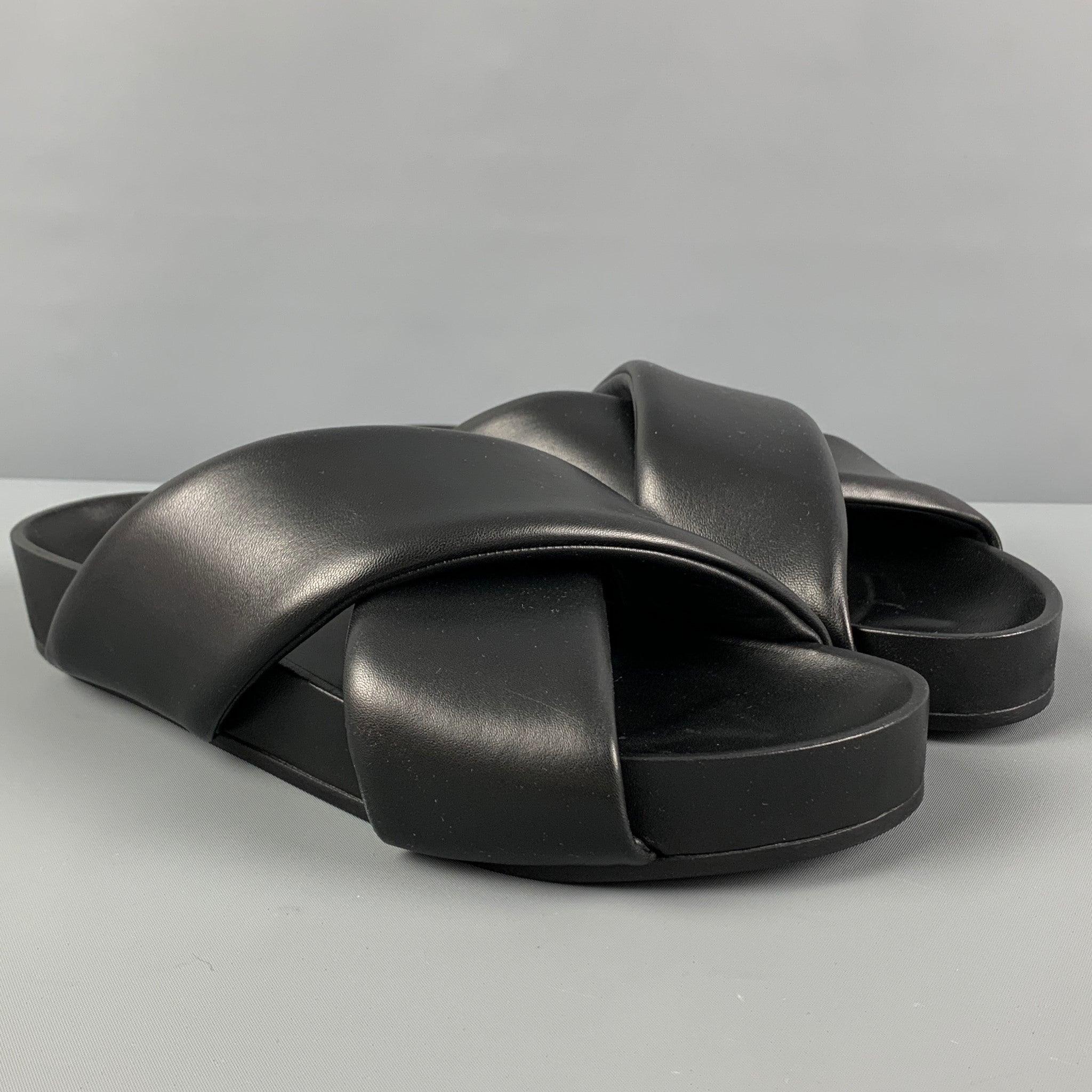 JIL SANDER sandals comes in a black leather featuring a wide criss cross strap design and a slip on style. Made in Italy.
 New With Box.
  
 

 Marked:  43Outsole: 11.25 inches x 4 inches 
  
  
  
 Sui Generis Reference: 121151
 Category: Sandals
