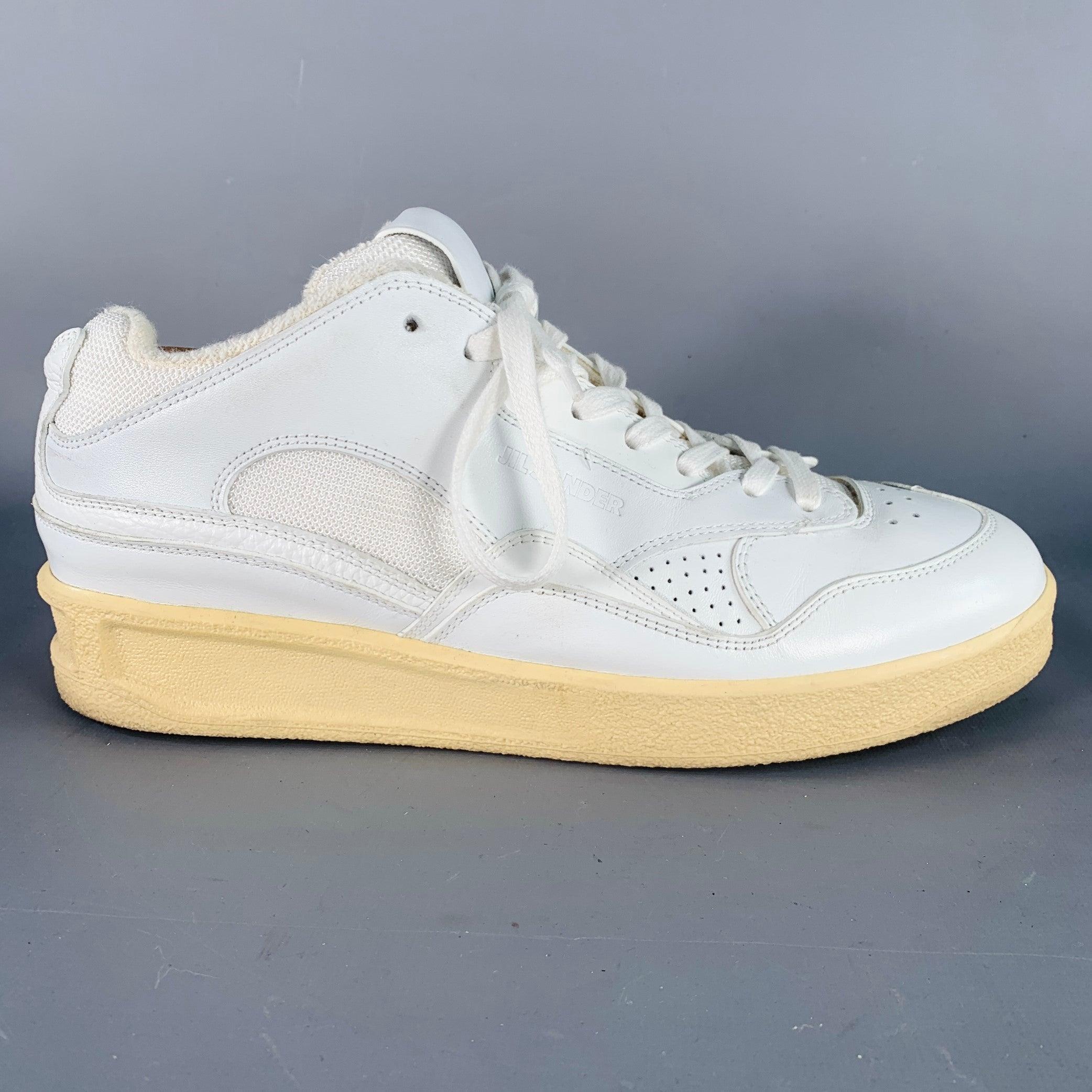 JIL SANDER sneakers
in a white leather featuring a low top style, chunky rubber sole, and lace-up closure. Shoe trees not included. Made in Italy.Very Good Pre-Owned Condition. Signs of wear on lining. 

Marked:   IT 43Outsole: 11.5 inches  x 4