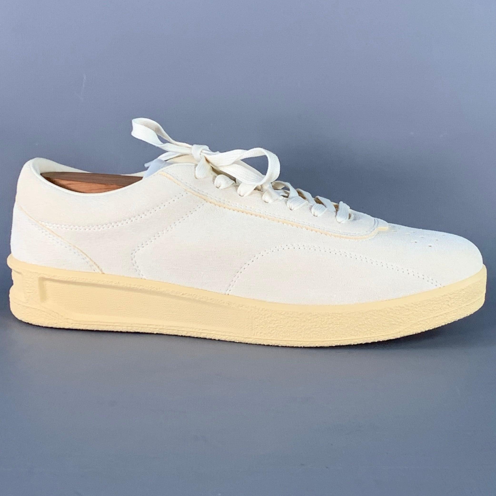 JIL SANDER sneakers
in a natural-colored suede featuring a low top style, textured rubber sole, and lace-up closure. Shoe trees not included. Comes with box. Made in Portugal.New with Box. 

Marked:   IT 45Outsole: 12 inches  x 4 inches 
  
  
 
Sui