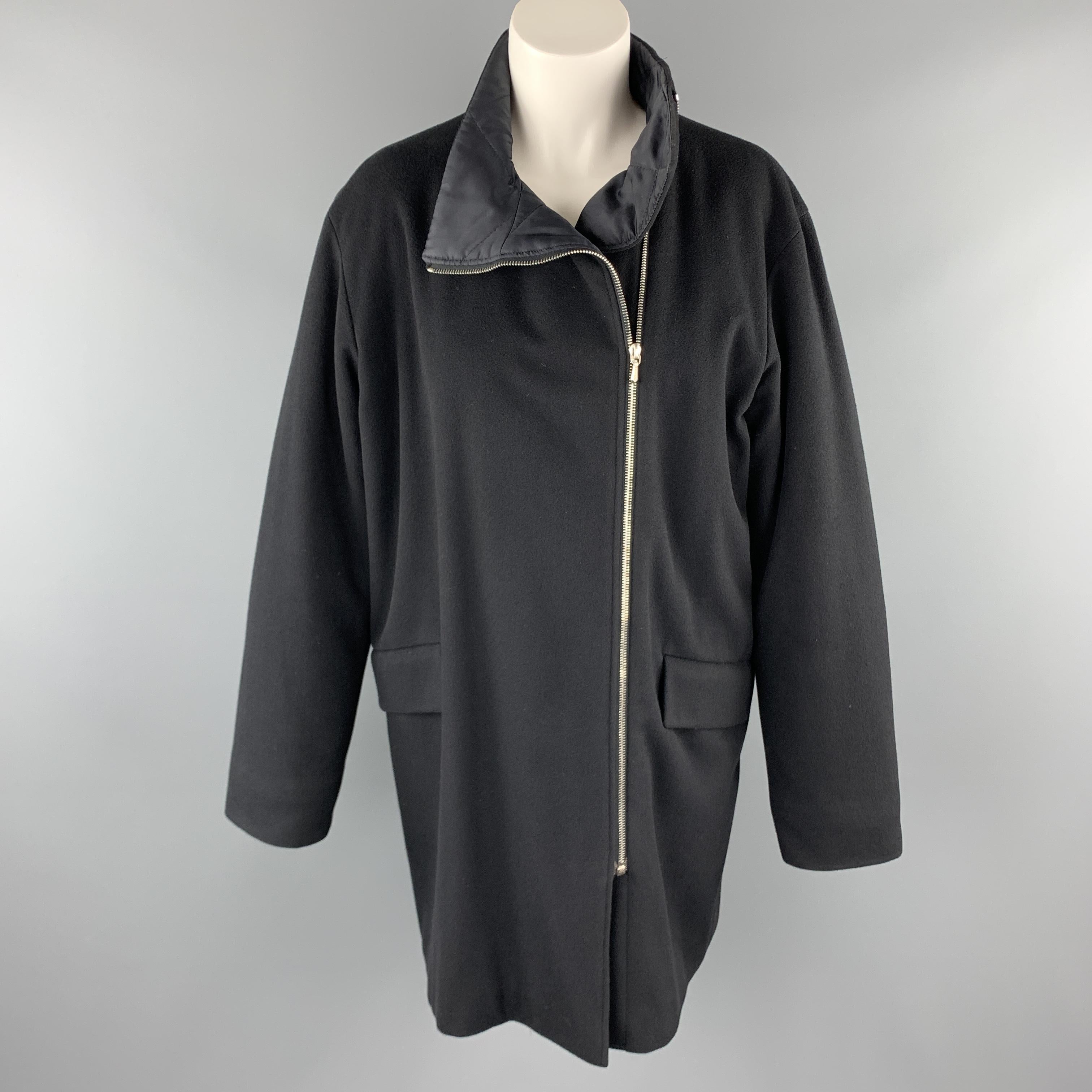 JIL SANDER over coat comes in deep navy blue wool blend with a high neck, flap pockets, quilted liner, and asymmetrical zip up front. Made in Italy.

Very Good Pre-Owned Condition.
Marked: IT 38
Original Retail Price: