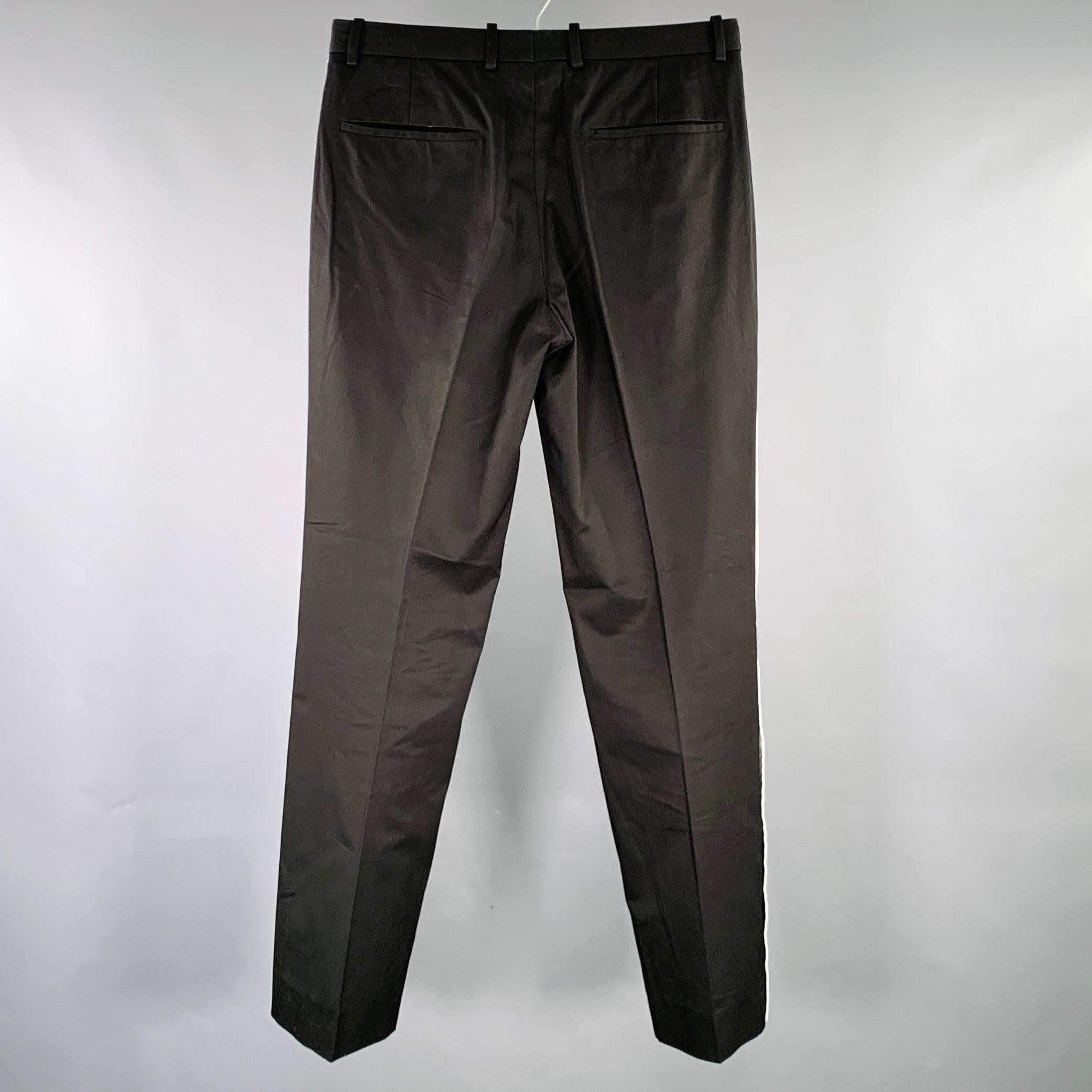 JIL SANDER dress pants
in a black and white cotton woven fabric featuring a flat front style, white vertical side stripes, and button fly closure. Made in Italy.Very Good Pre-Owned Condition. Minor signs of wear. 

Marked:   IT 46 

Measurements: 
 