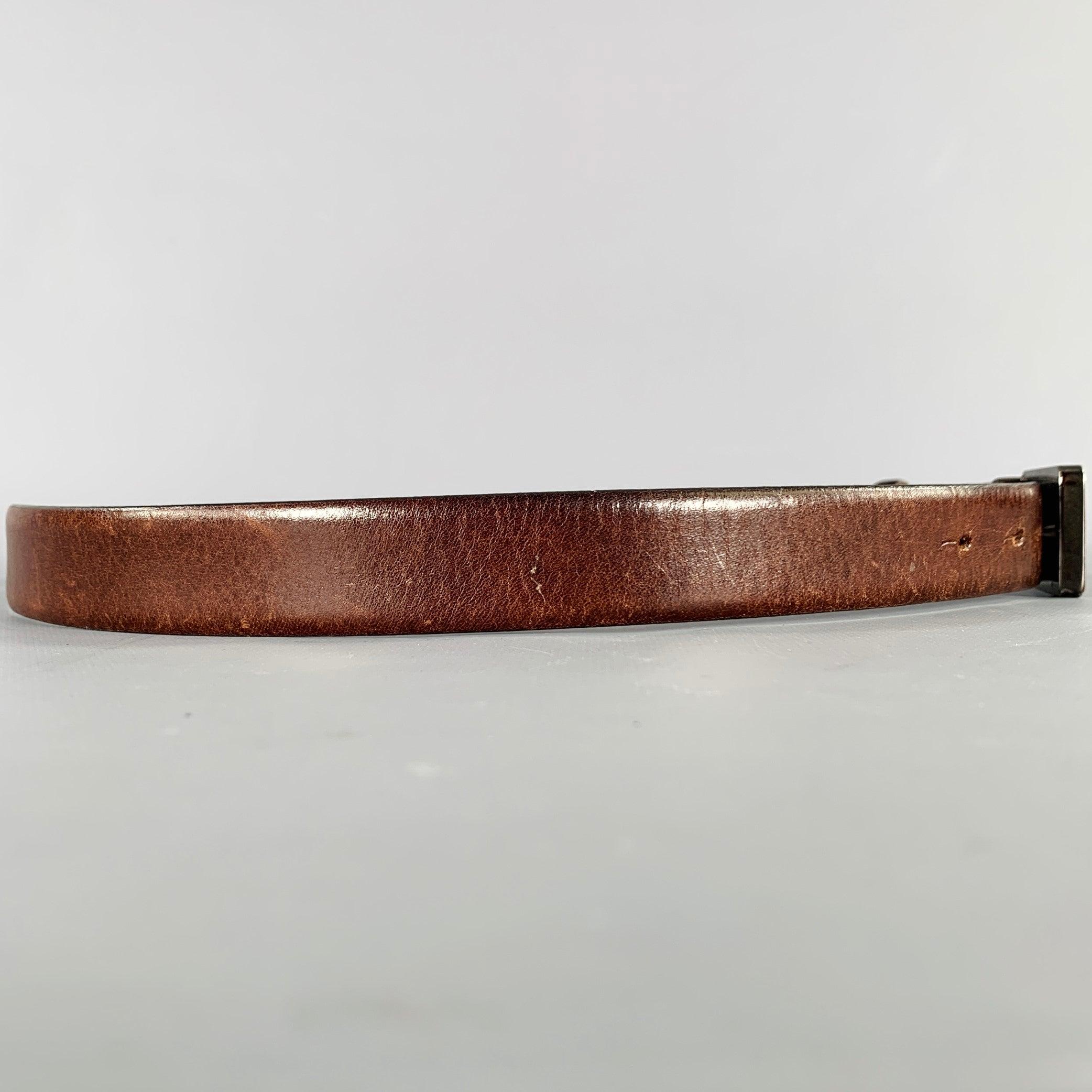 JIL SANDER belt in a brown leather featuring a wooden anchor-style buckle. Made in Italy.Excellent Pre-Owned Condition. 

Marked:   801020 581100Length: 41 inches Width: 1 inches Fits: 35 inches  - 37 inches Buckle: 2.25 inches 
  
  
 
Sui Generis