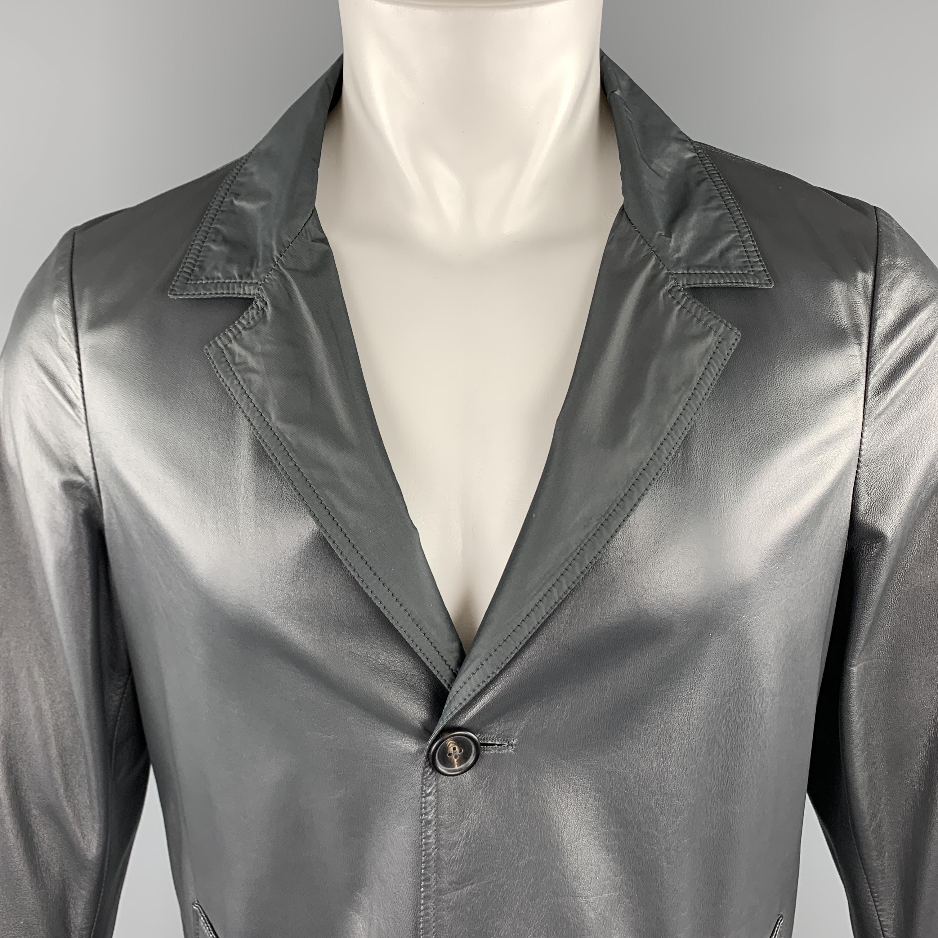 JIL SANDER coat comes in soft gray leather with a notch lapel, single breasted, three button closure, slit pockets, and reverse nylon side. Wear on liner. As-is. Otherwise Excellent condition. Made in Italy.

Very Good Pre-Owned Condition.
Marked: