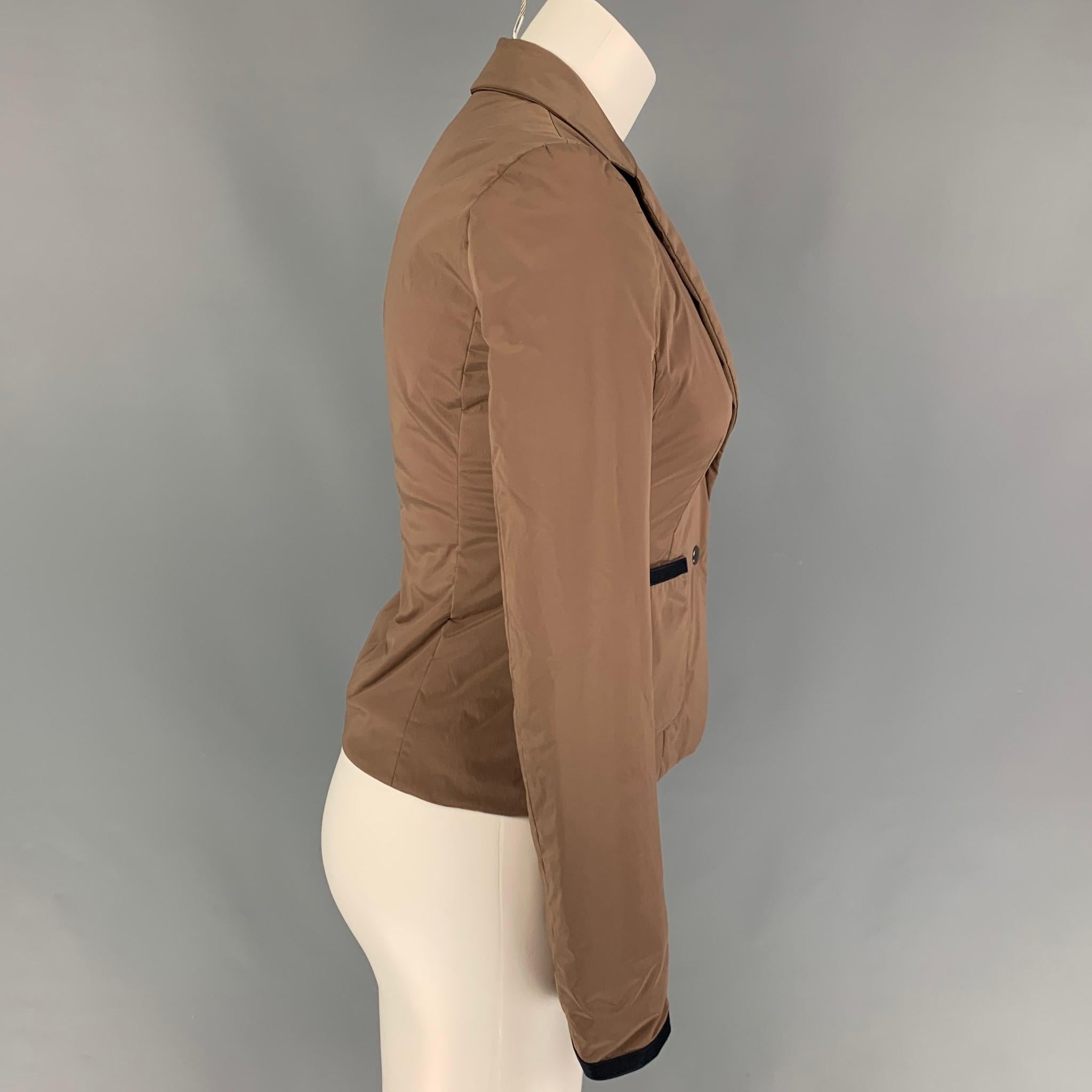 JIL SANDER NAVY blazer comes in a khaki polyamide blend featuring a notch lapel, patch pockets, and a two snap button closure. Made in Italy. 

Very Good Pre-Owned Condition.
Marked: 34

Measurements:

Shoulder: 14.5 in.
Bust: 32 in.
Sleeve: 24.5