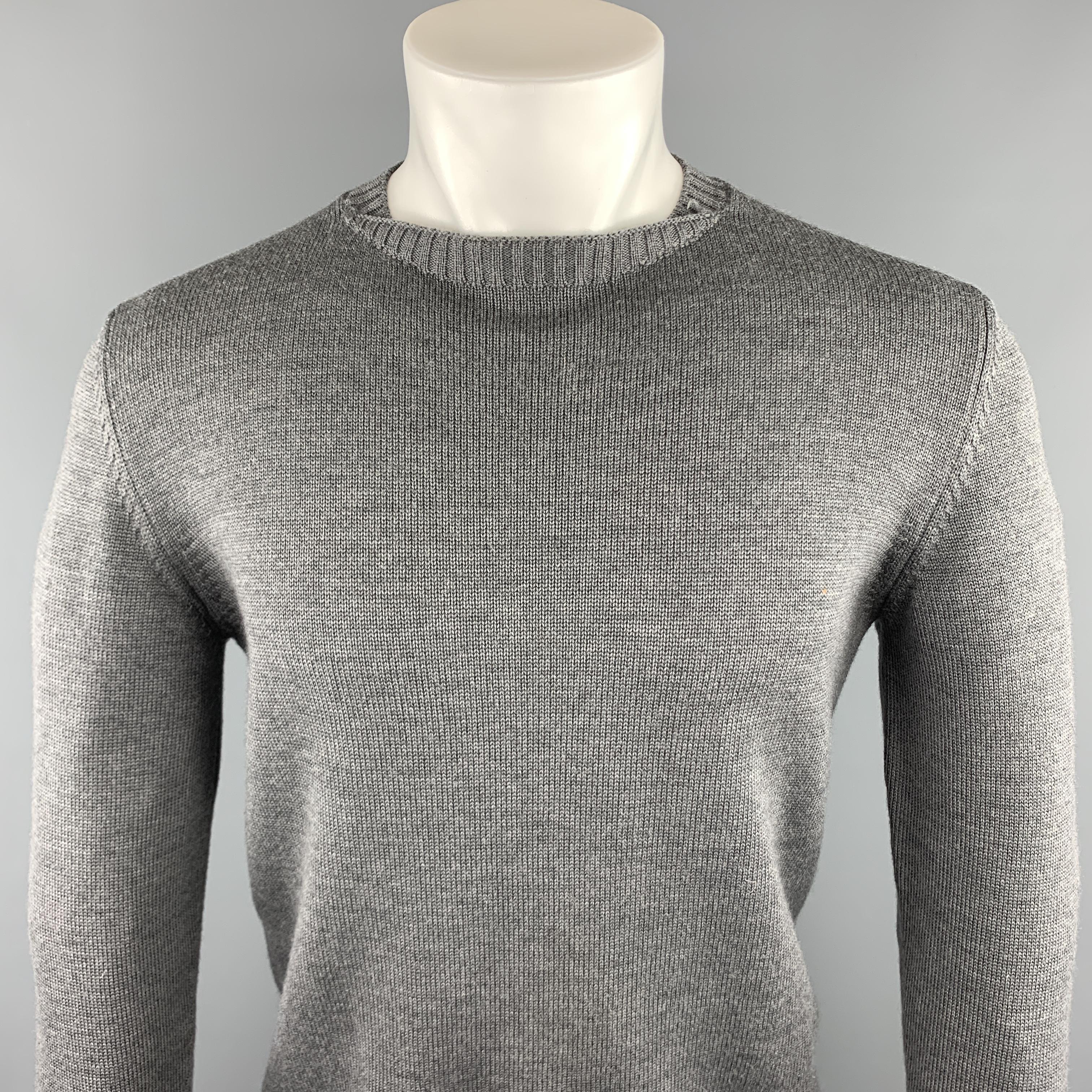 JIL SANDER sweater comes in a dark gray knitted wool featuring a ribbed crew-neck. Made in Italy.

Excellent Pre-Owned Condition.
Marked: IT 50

Measurements:

Shoulder: 18 in. 
Chest: 40 in.
Sleeve: 26 in. 
Length: 25.5 in.