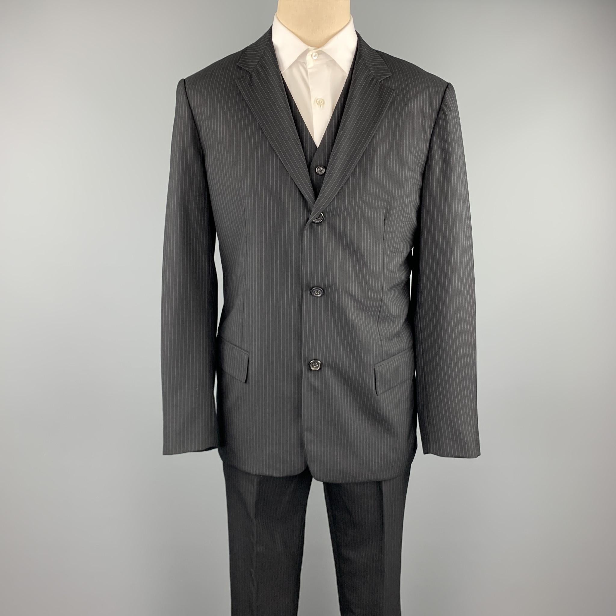 JIL SANDER suit comes in a black stripe wool and includes a single breasted, three button sport coat with a notch lapel and matching vest & flat front trousers. Made in Italy.

Excellent Pre-Owned Condition.
Marked: IT L