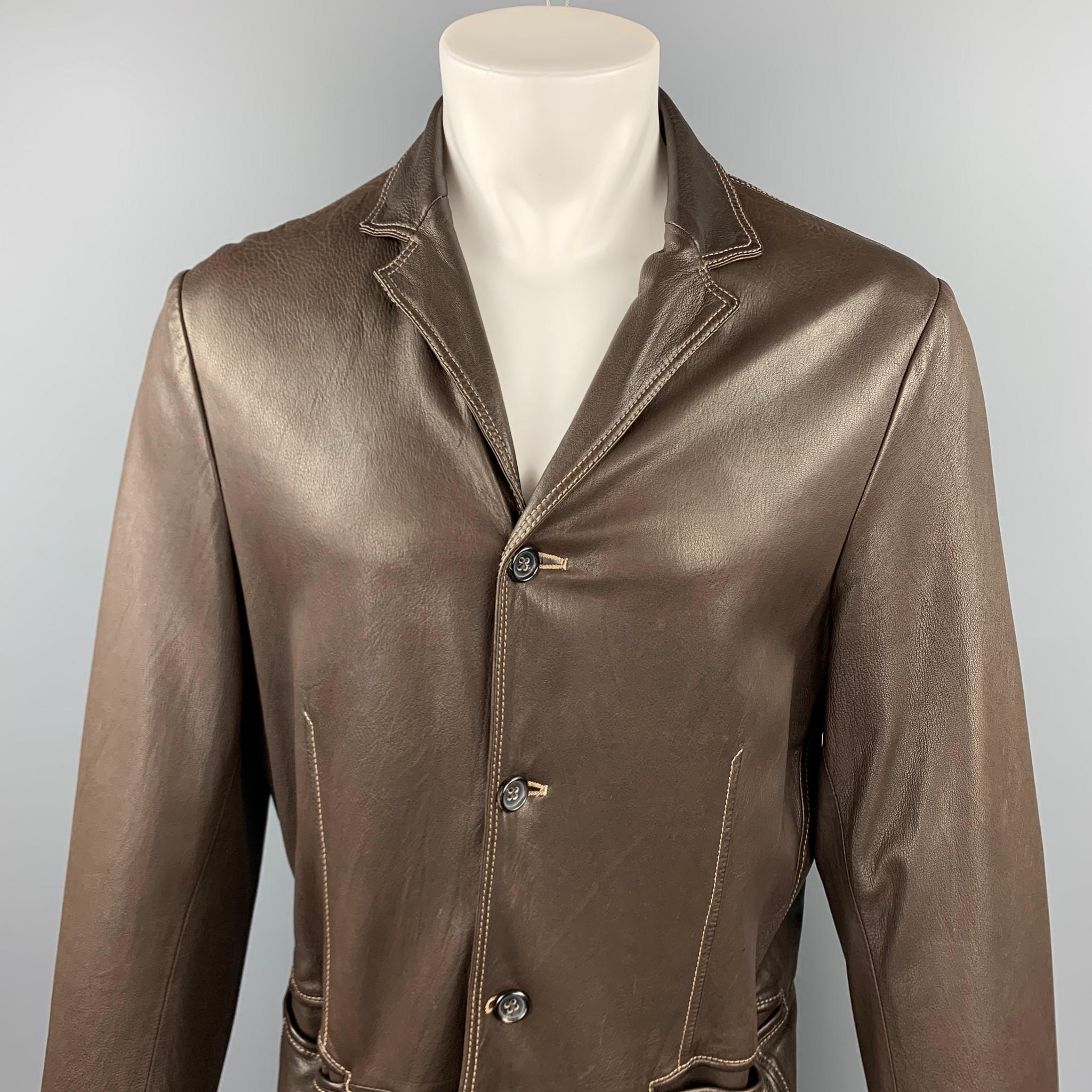 JIL SANDER jacket comes in a brown leather with contrast stitching featuring a notch lapel, slit pockets, and a three button closure. Made in Italy. 

Very Good Pre-Owned Condition.
Marked: IT 52

Measurements:

Shoulder: 17.5 in.
Chest: 42 in.