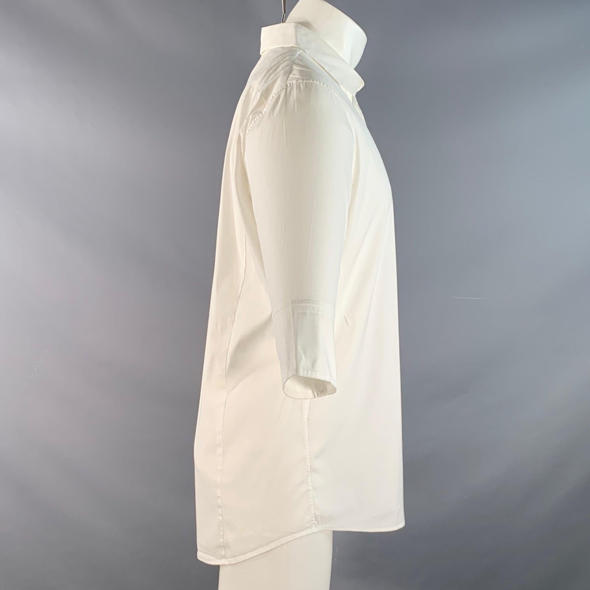 Camicia a maniche lunghe Jil Sander in misto cotone bianco con maniche a 3/4, colletto aperto e pacchetto nascosto. Prodotto in Italia. Ottimo stato usato. 

Contrassegnato:   42 

Misure: 
 
Spalla: 18,5 pollici Petto: 42 pollici Manica: 26,5