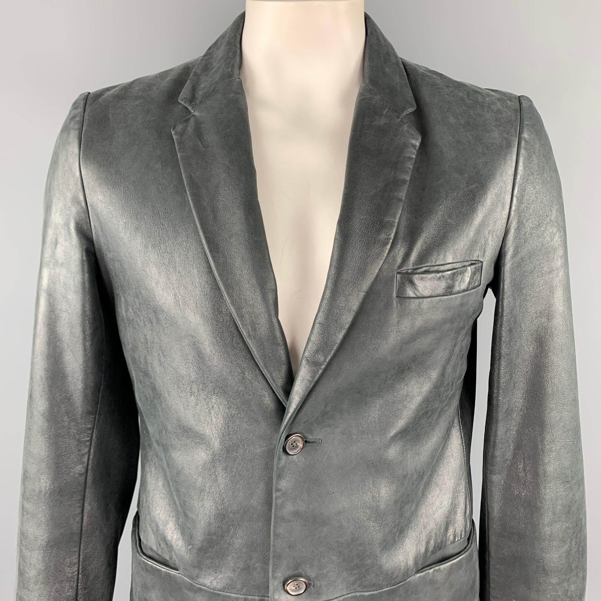 JIL SANDER jacket comes in a charcoal distressed leather featuring a notch lapel, slit pockets, and a two button closure. Made in Italy.

Very Good Pre-Owned Condition.
Marked: IT 54

Measurements:

Shoulder: 18.5 in.
Chest: 42 in. 
Sleeve: 28.5 in.
