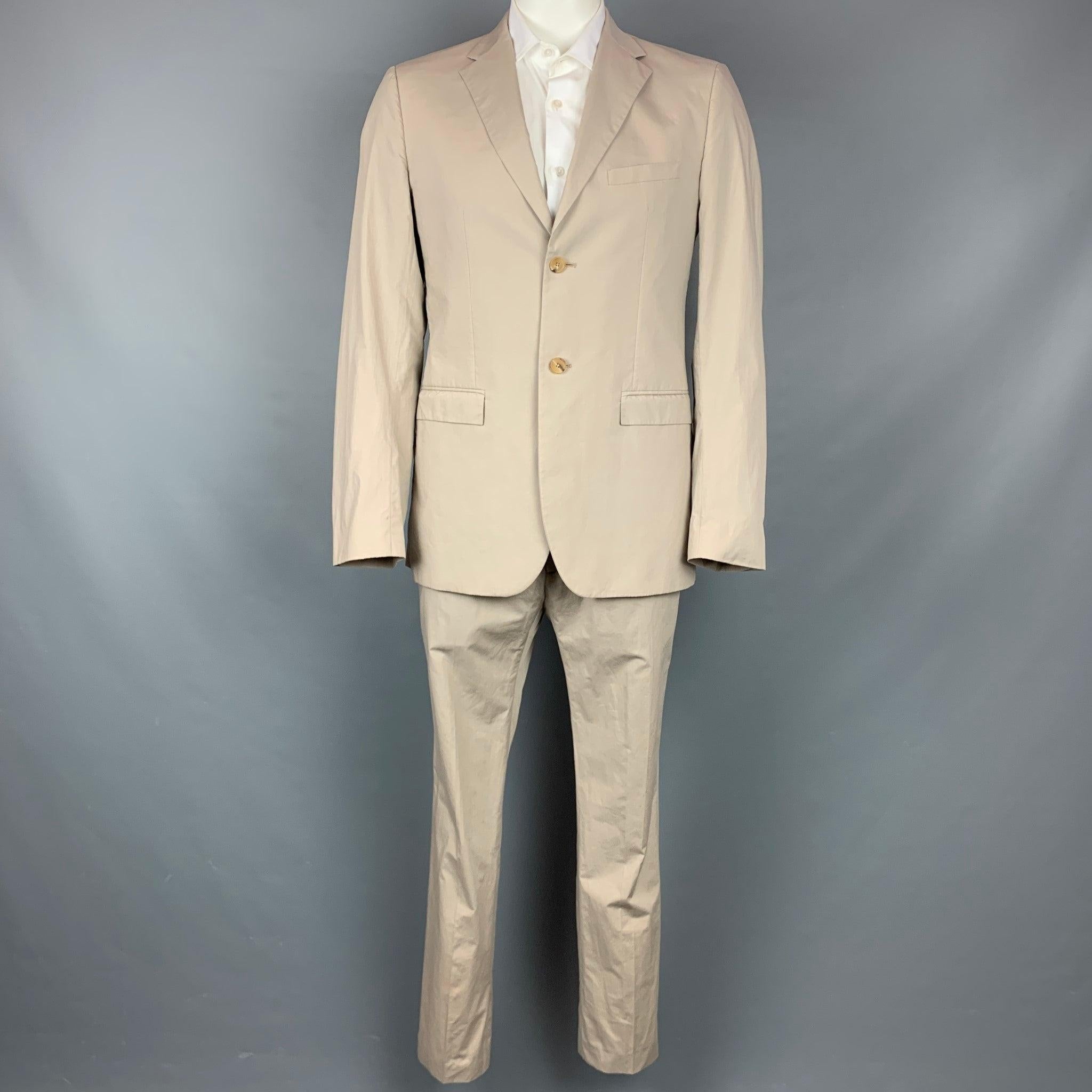 JIL SANDER
suit comes in khaki cotton with a full liner and includes a single breasted, two button sport coat with a notch lapel and matching flat front trousers. Made in Italy. Good Pre-Owned Condition. Light marks at front.  

Marked:   Jacket: IT