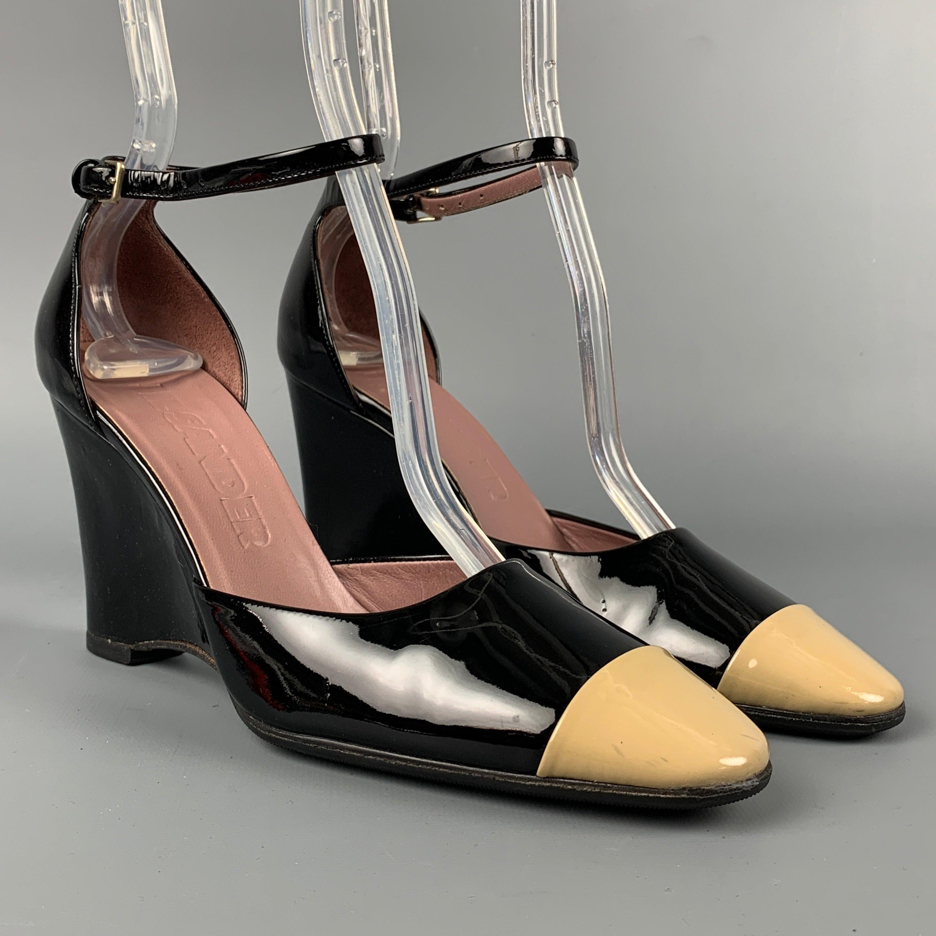 JIL SANDER pumps comes in a black & nude color block patent leather comes in a cap toe, narrow fit, wedge heel, and a ankle strap closure.
Very Good
Pre-Owned Condition. 

Marked:   No size marked.  

Measurements: 
  Heel: 3.5 inches 
  
  
