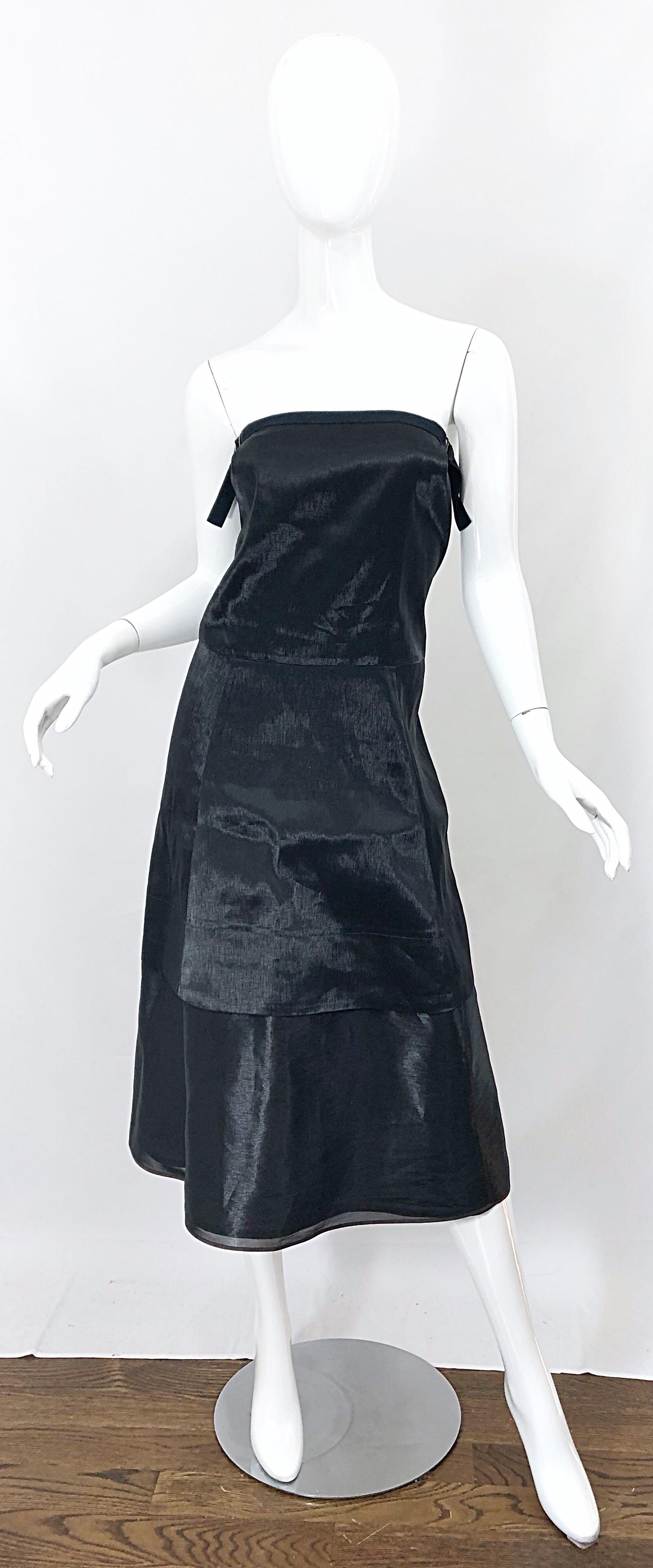 Chic minimalist at its best! This 1990s JIL SANDER strapless dress is so much more than a classic little black dress. You will find yourself wondering if you are wearing a black or gunmetal dress. Beautiful metallic 'wet look' fabric gives off the