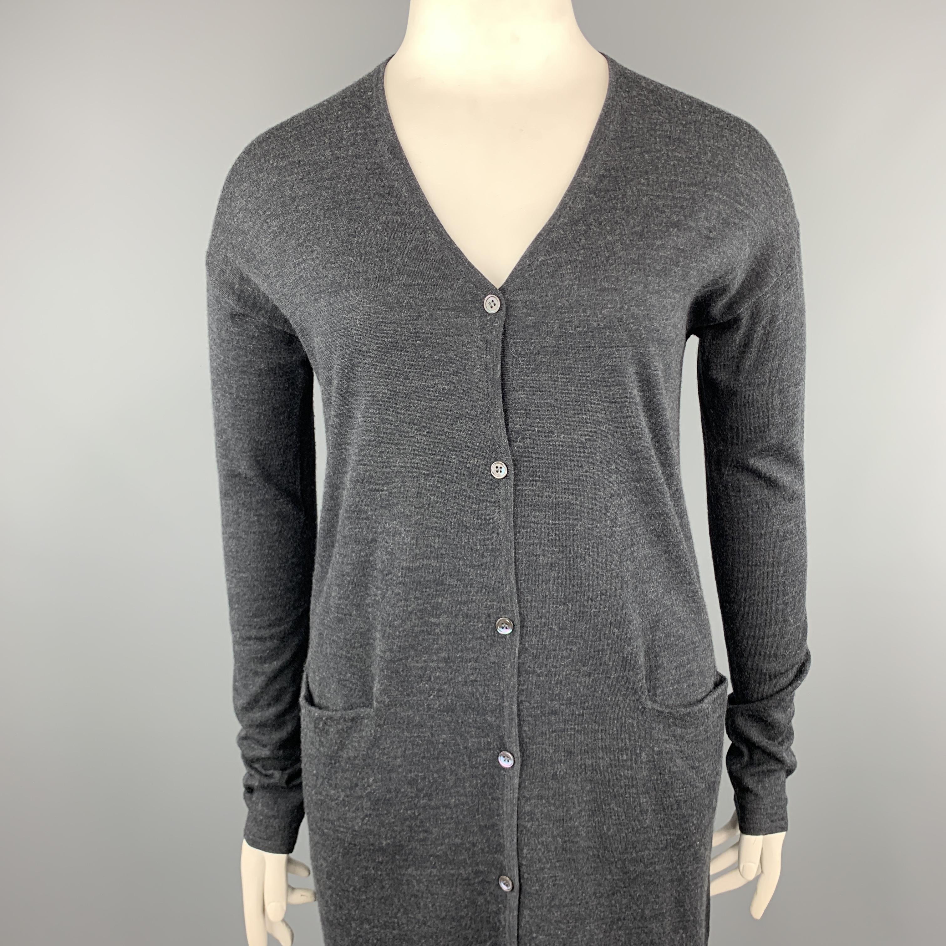 JIL SANDER duster cardigan comes in a light heather charcoal gray wool jersey knit with a deep V neckline, pockets, and extended long sleeves.

Excellent Pre-Owned Condition.
Marked: L

Measurements:

Shoulder: 24 in.
Bust: 44 in.
Sleeve: 24