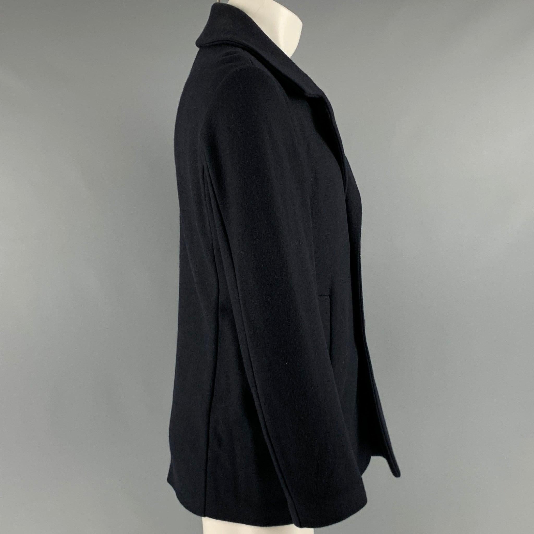 JIL SANDER coat
in a navy wool fabric featuring a double breasted peacoat style, two pockets, and button closure. Made in Italy.Excellent Pre-Owned Condition. 

Marked:   size not marked, size tag removed. 

Measurements: 
 
Shoulder: 16.5 inches