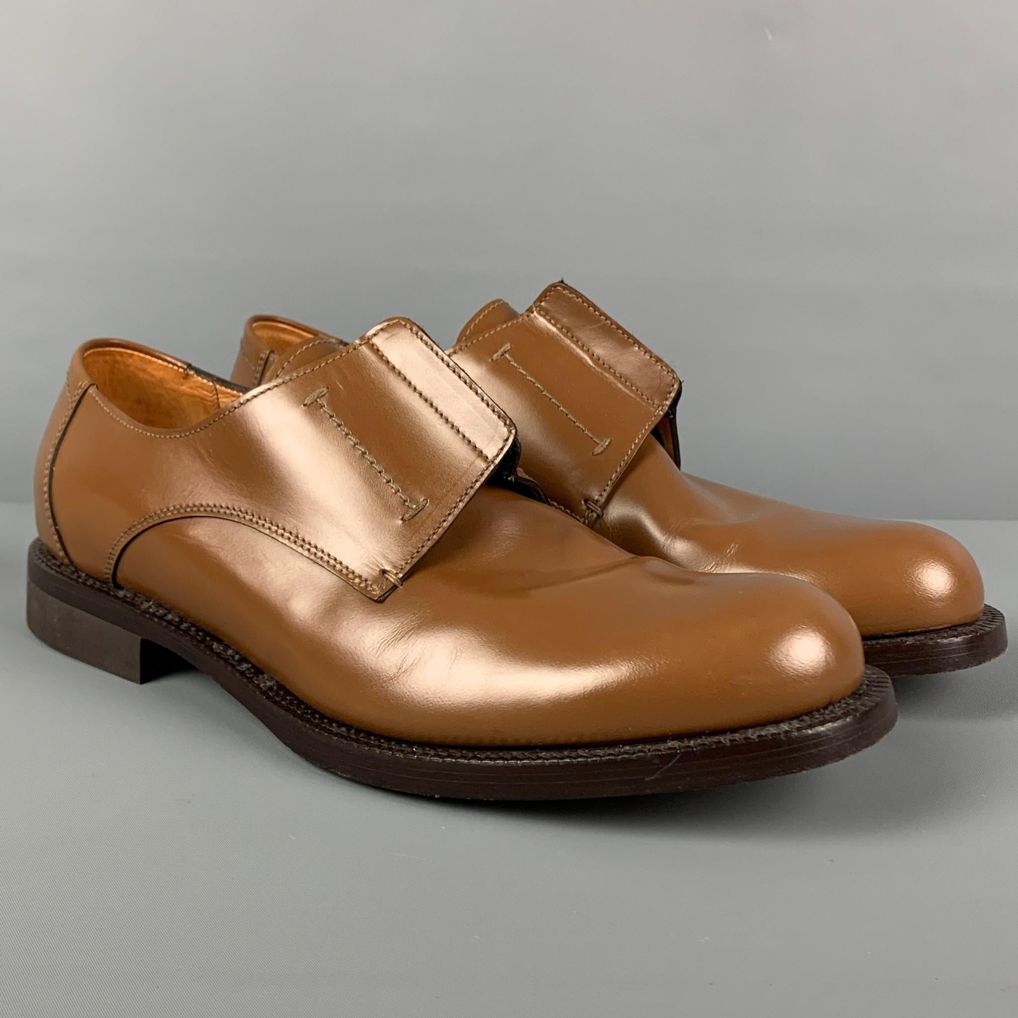 JIL SANDER x RAF SIMONS dress shoes comes in a tan leather featuring a elastic detail, round toe, and a laceless closure. Made in Italy. 

Very Good Pre-Owned Condition.
Marked: 1 0029 10

Outsole: 12.75 in. x 4.5 in. 