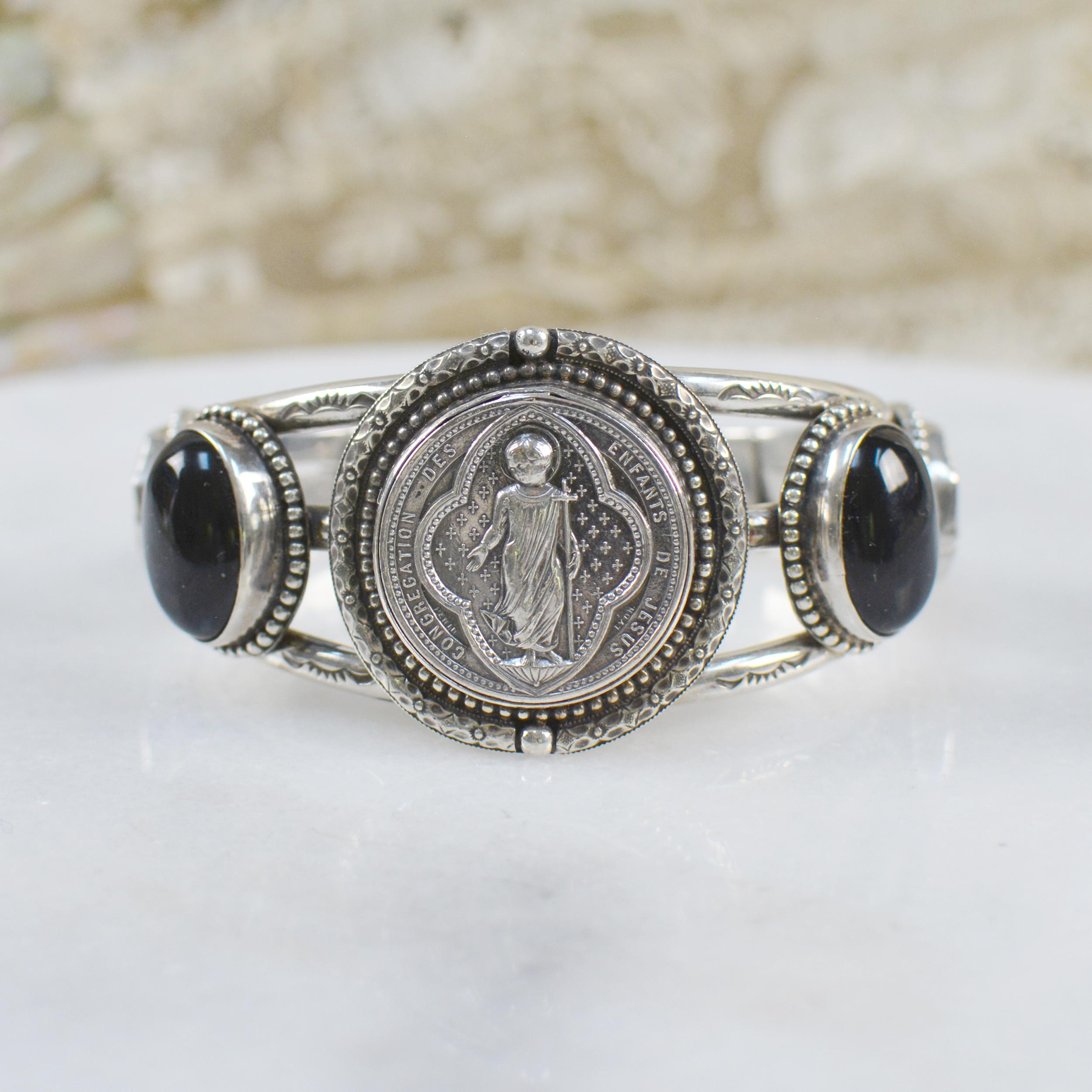This one of a kind sterling silver Jill Garber cuff bracelet features a fine original antique nineteenth century French Sacred Heart Medal by engraver  Ludovic Penin, depicting the Christ child. Ludovic Penin 1830 - 1868, French master engraver was